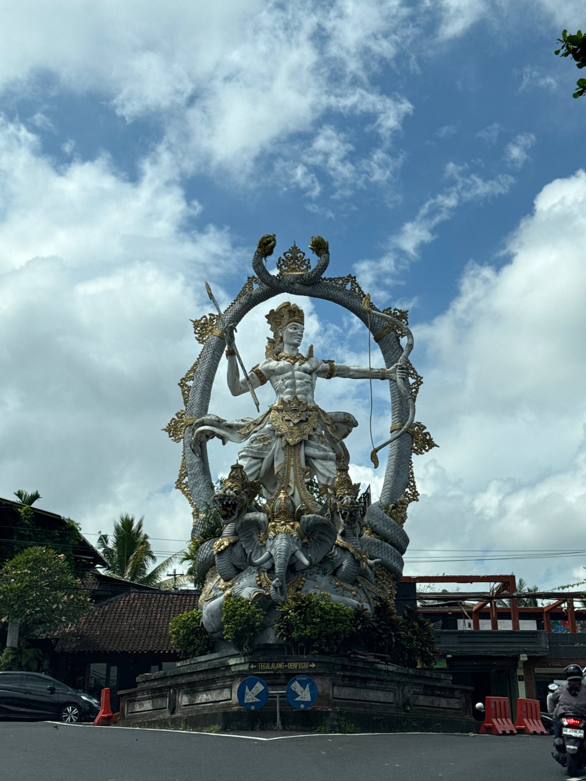 Balinese Hindu statue observed during daytime traffic in Ubud