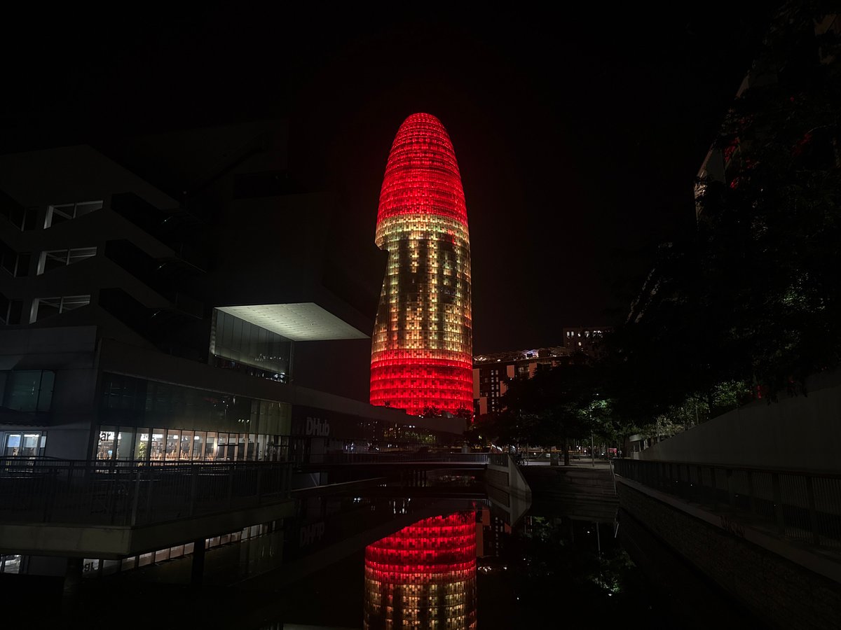 Torre Glòries illuminated as crowds gather in Barcelona streets