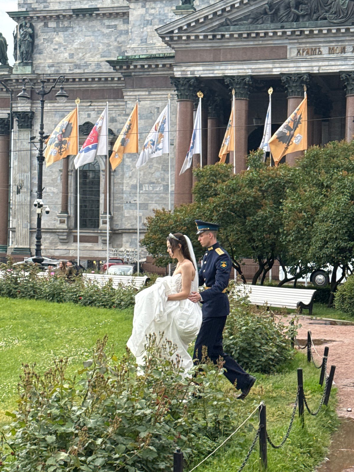 Wedding celebration outside a grand classical building in Saint Petersburg