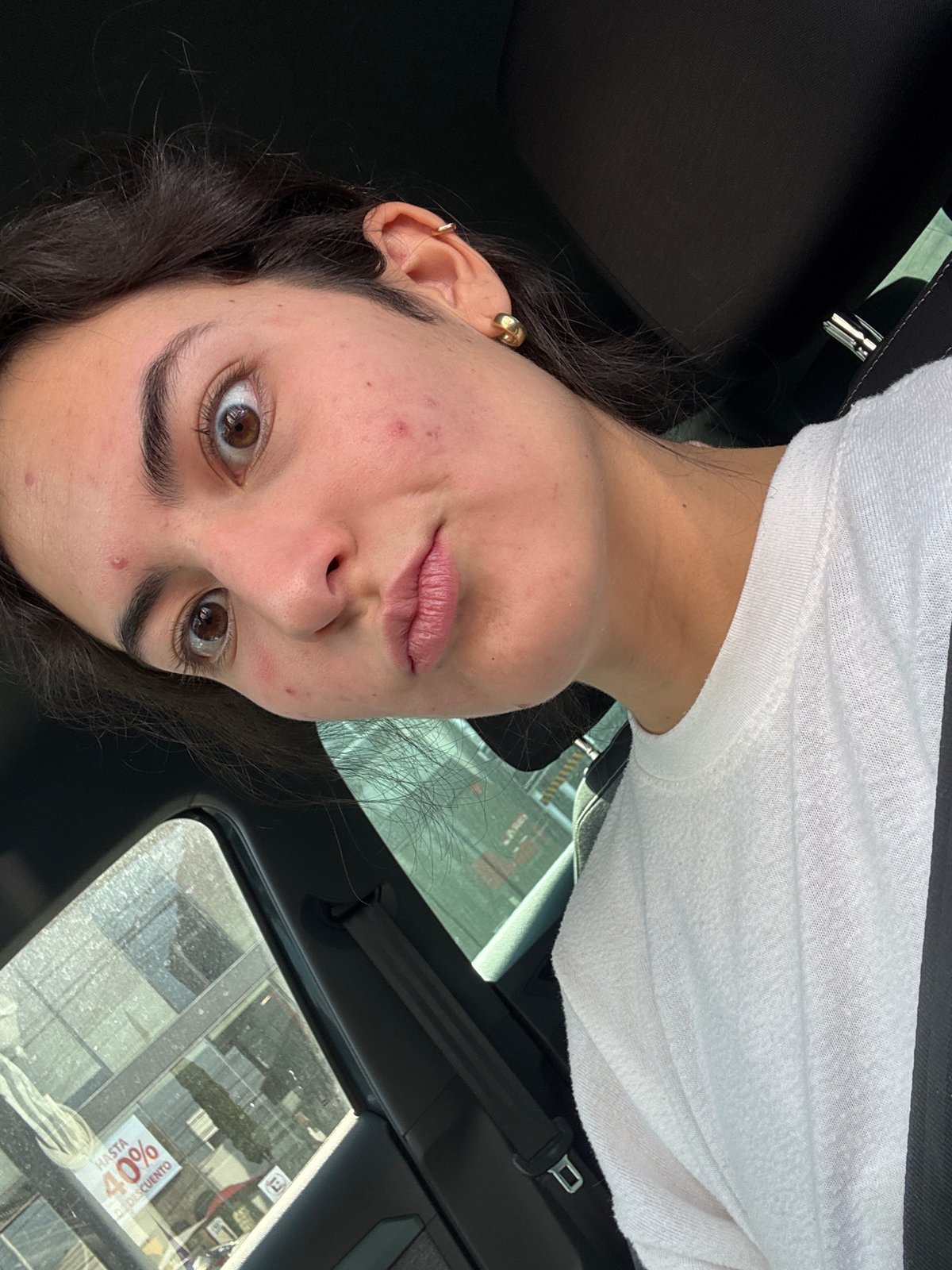 Young woman photographed inside car in Puebla, Mexico