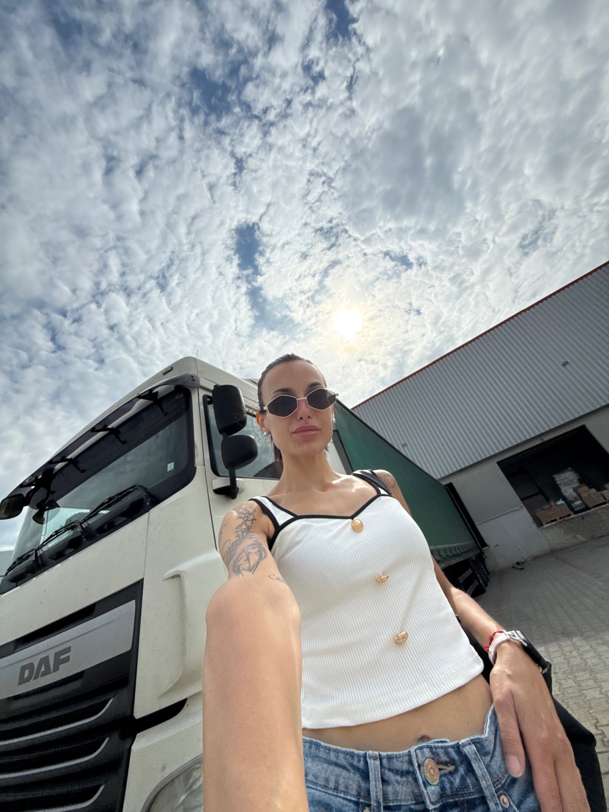 Woman poses beside white truck in Pleven, Bulgaria