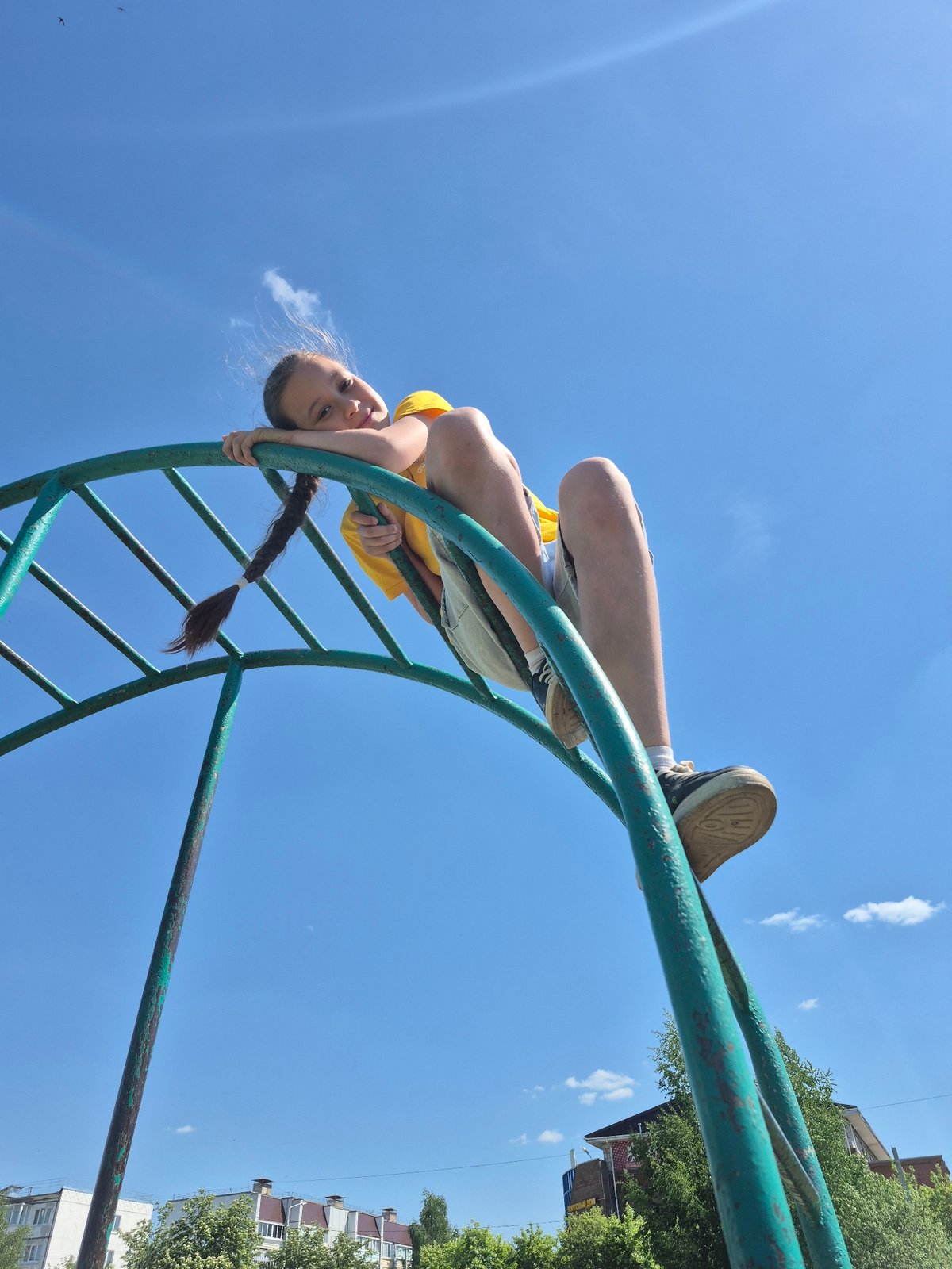 Children play on playground equipment during morning hours