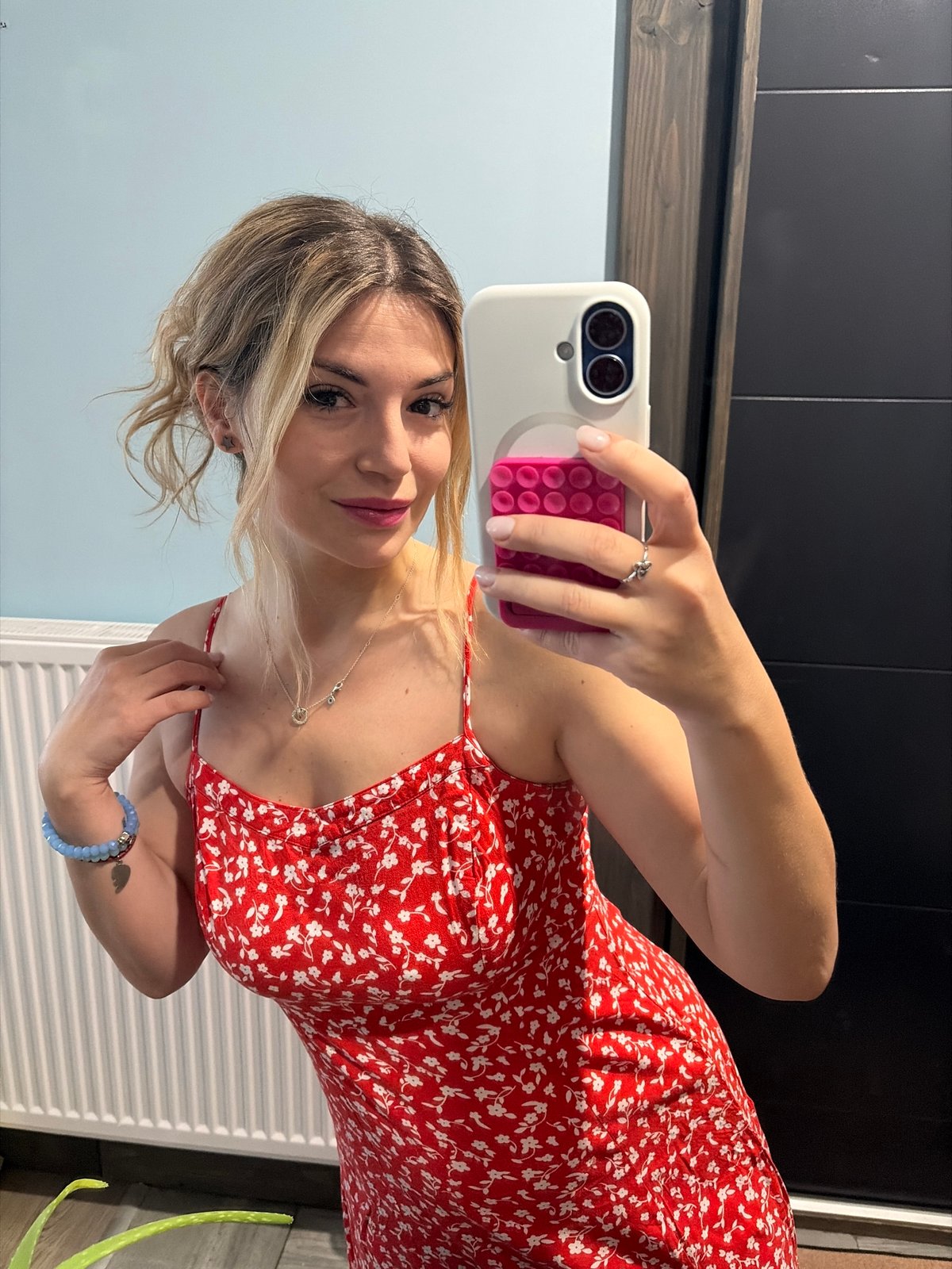 Woman takes selfie in red dress, Wisła Poland
