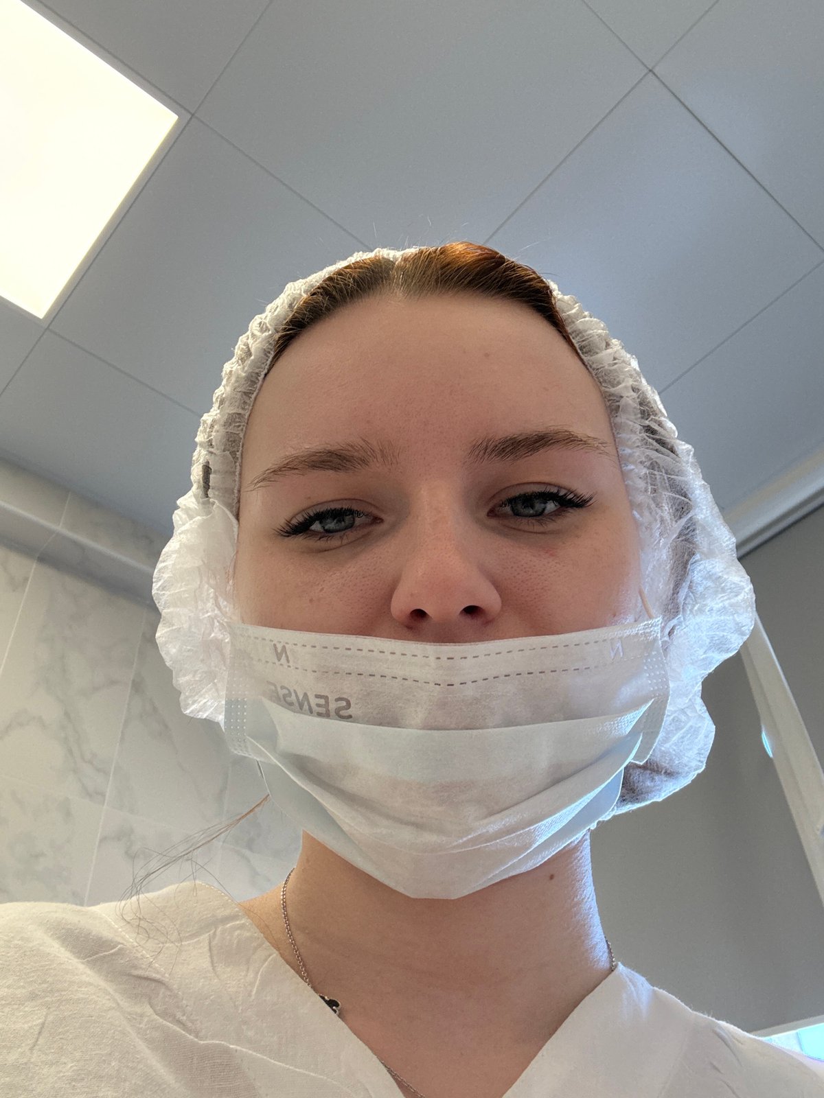 Person in medical mask with 'SENSE' text spotted in Saint Petersburg