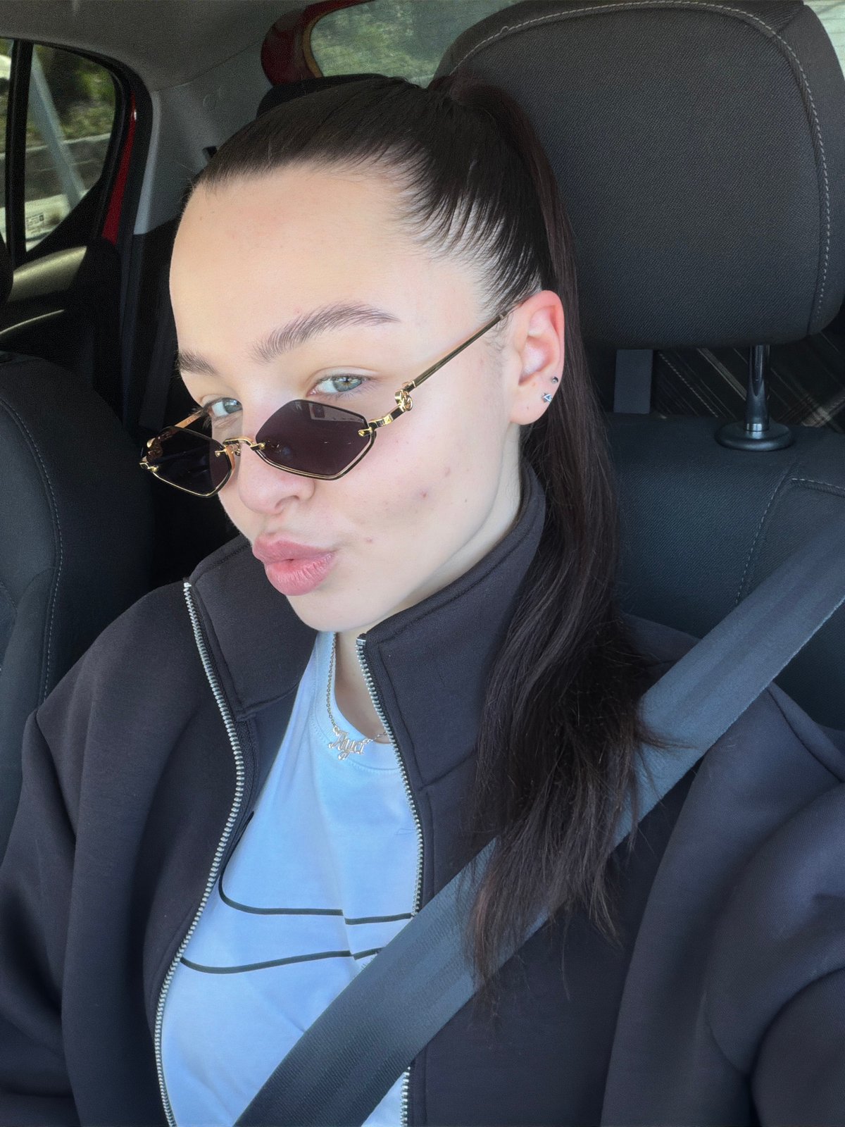 Woman photographed in car wearing sunglasses in Pernik