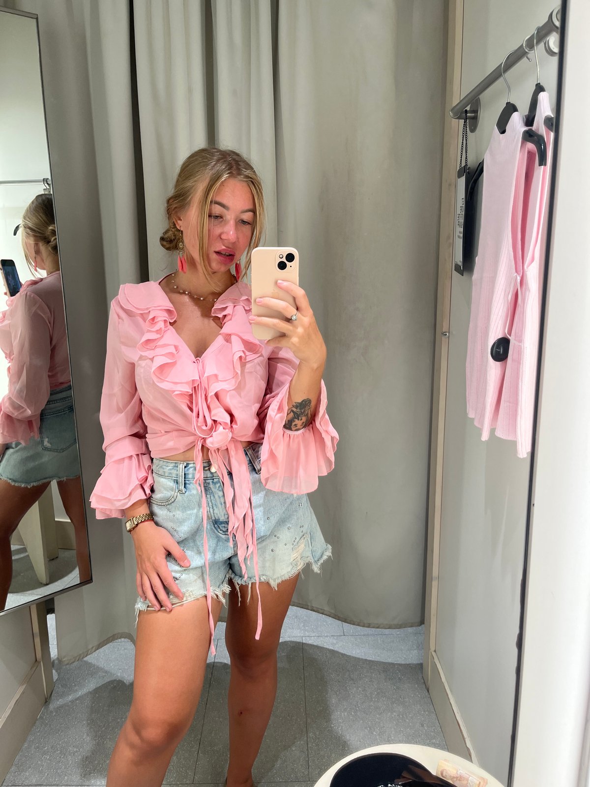 Woman takes selfie in retail changing room in Thailand