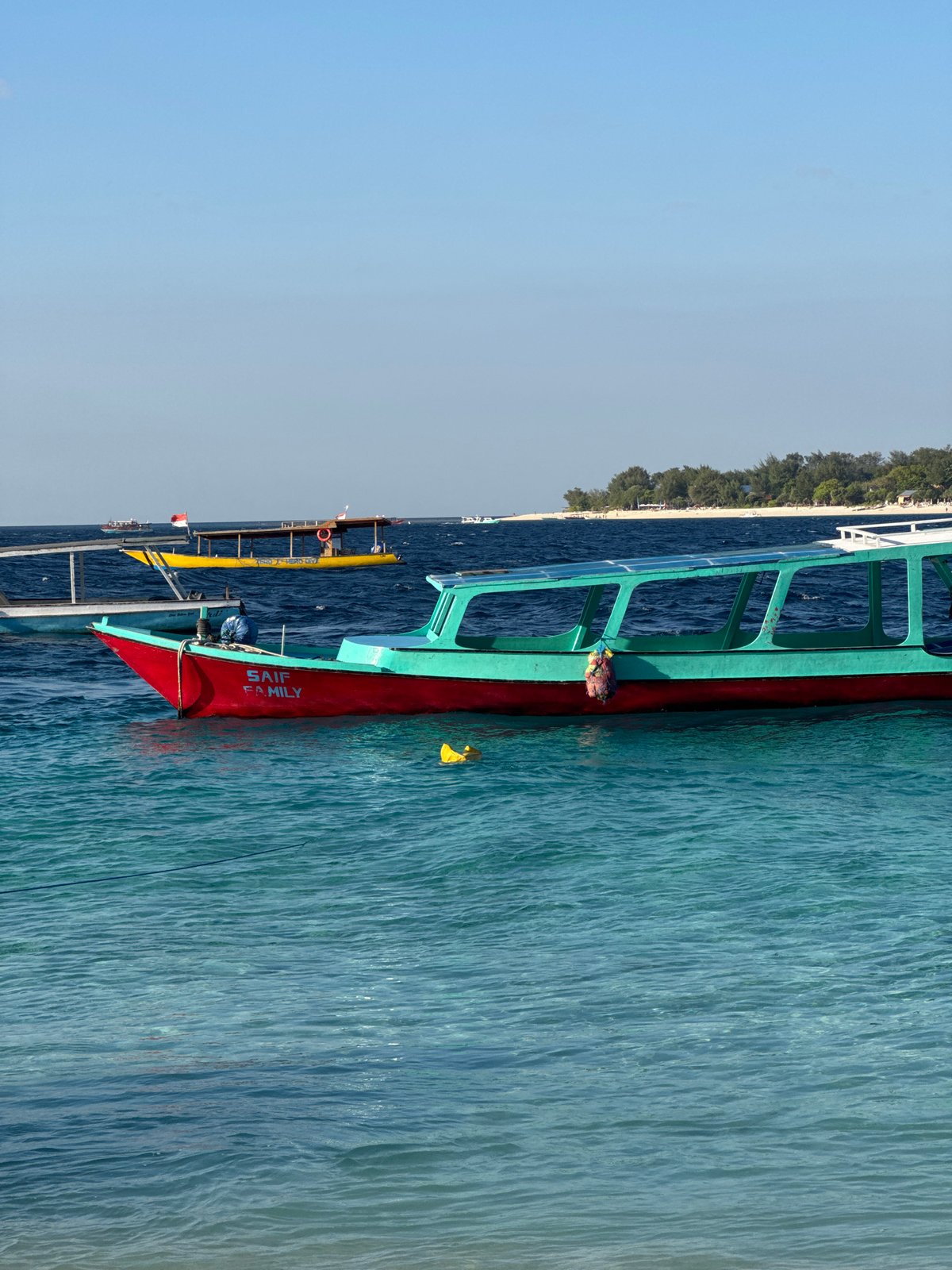 Boats, beach soccer, and turquoise water at the Gili Islands