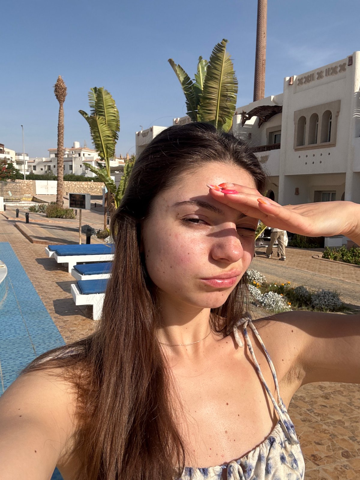 Woman documents tropical resort vacation in morning photo session
