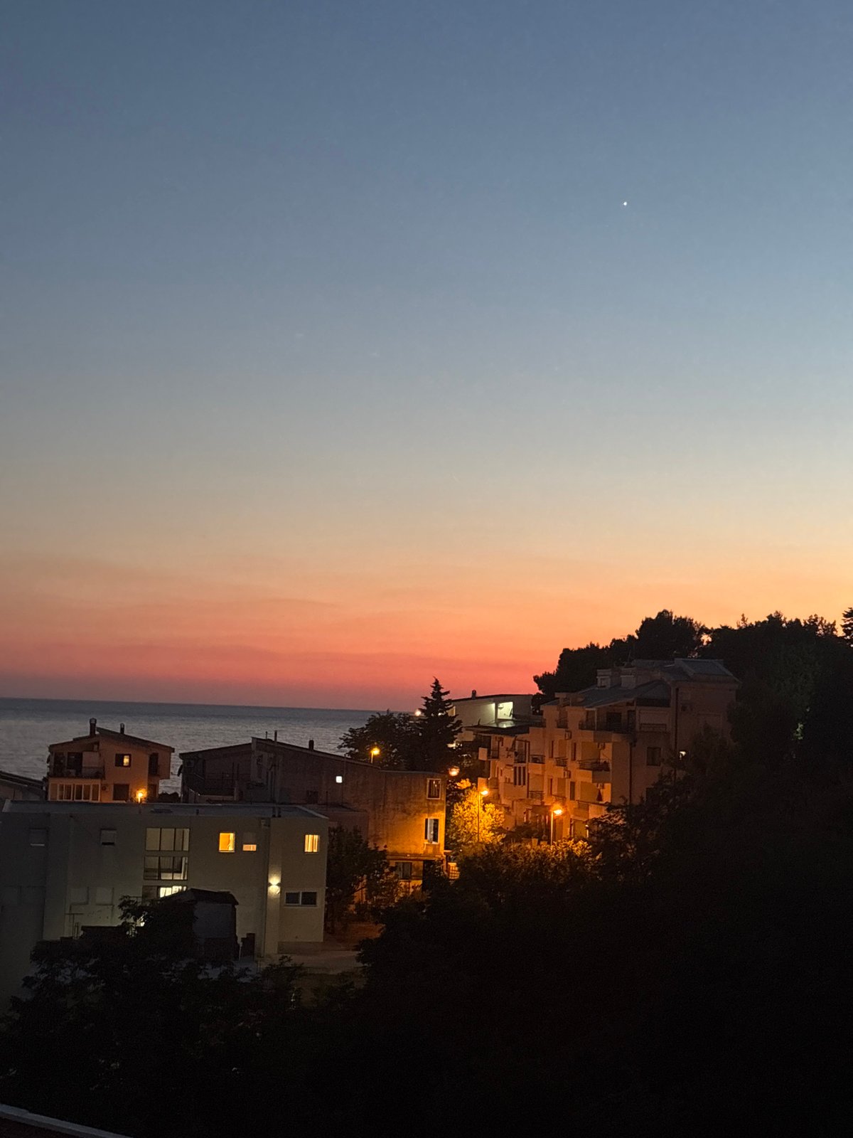Dusk settles over Bar, Montenegro's coastline and rooftops