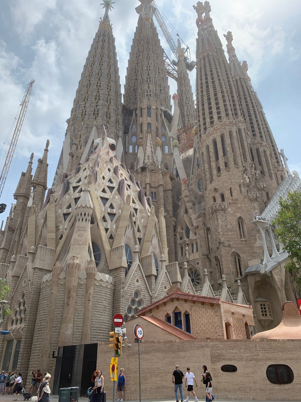 Skateboarder visits Barcelona's Sagrada Familia on sunny Tuesday morning
