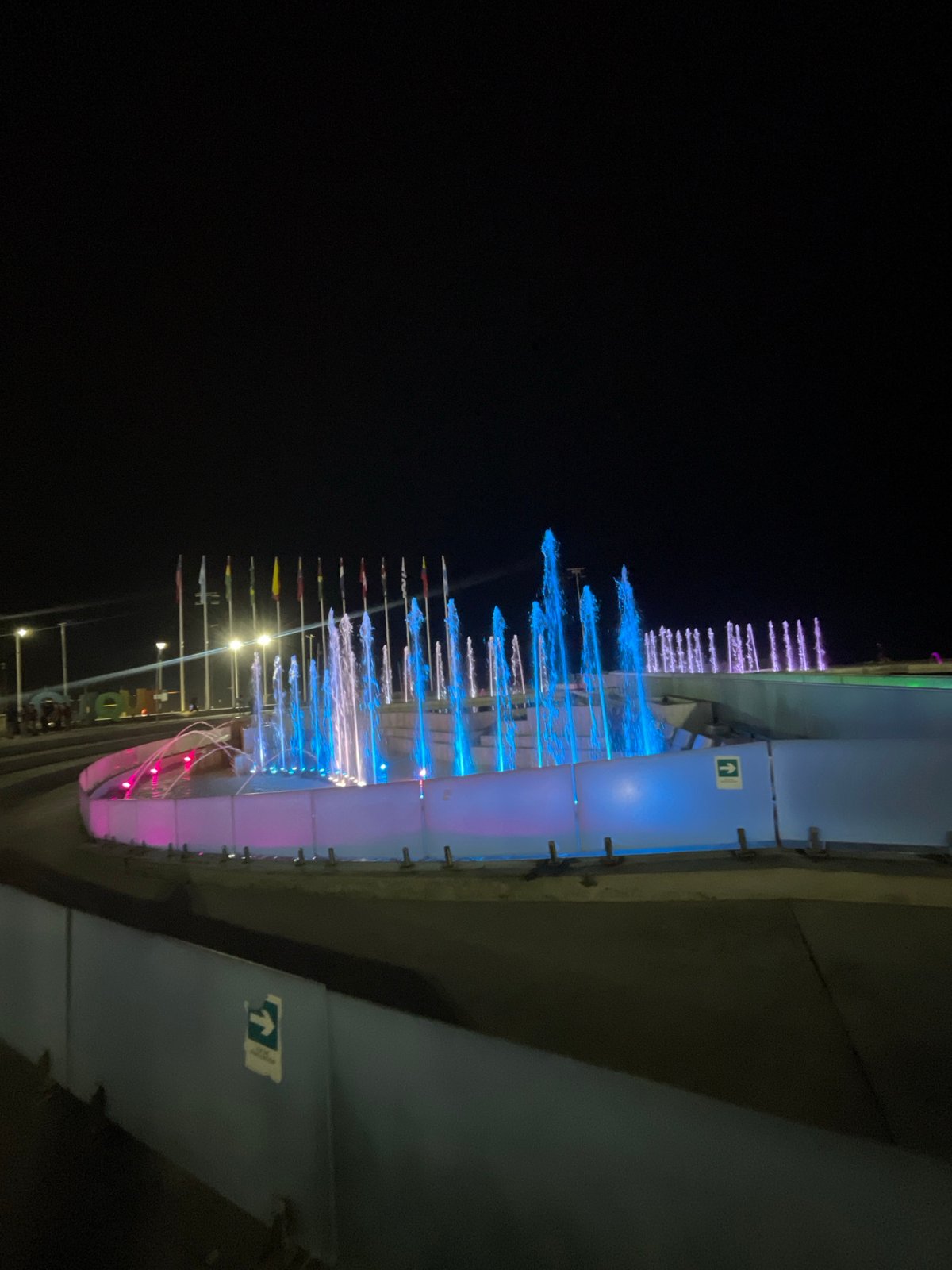 Illuminated fountain operates at night in Iquique pedestrian area
