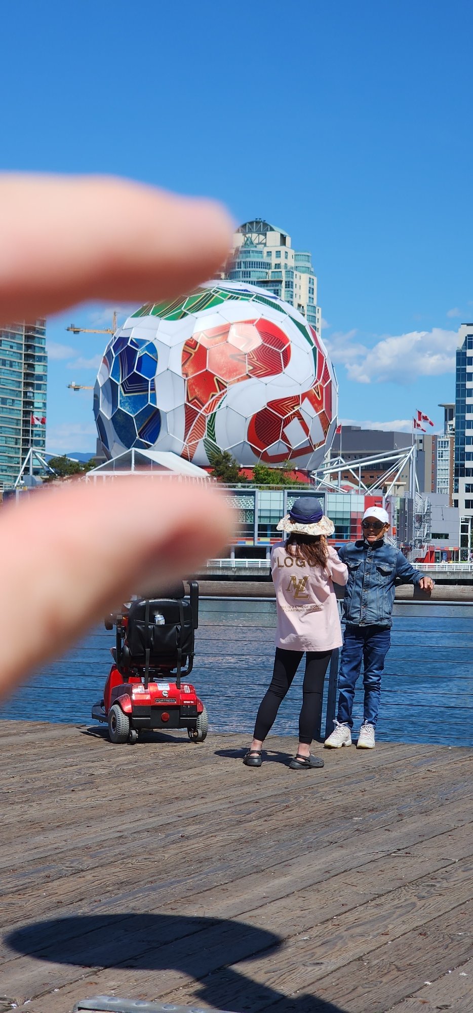 Police patrol waterfront area with art installations and ferry activity