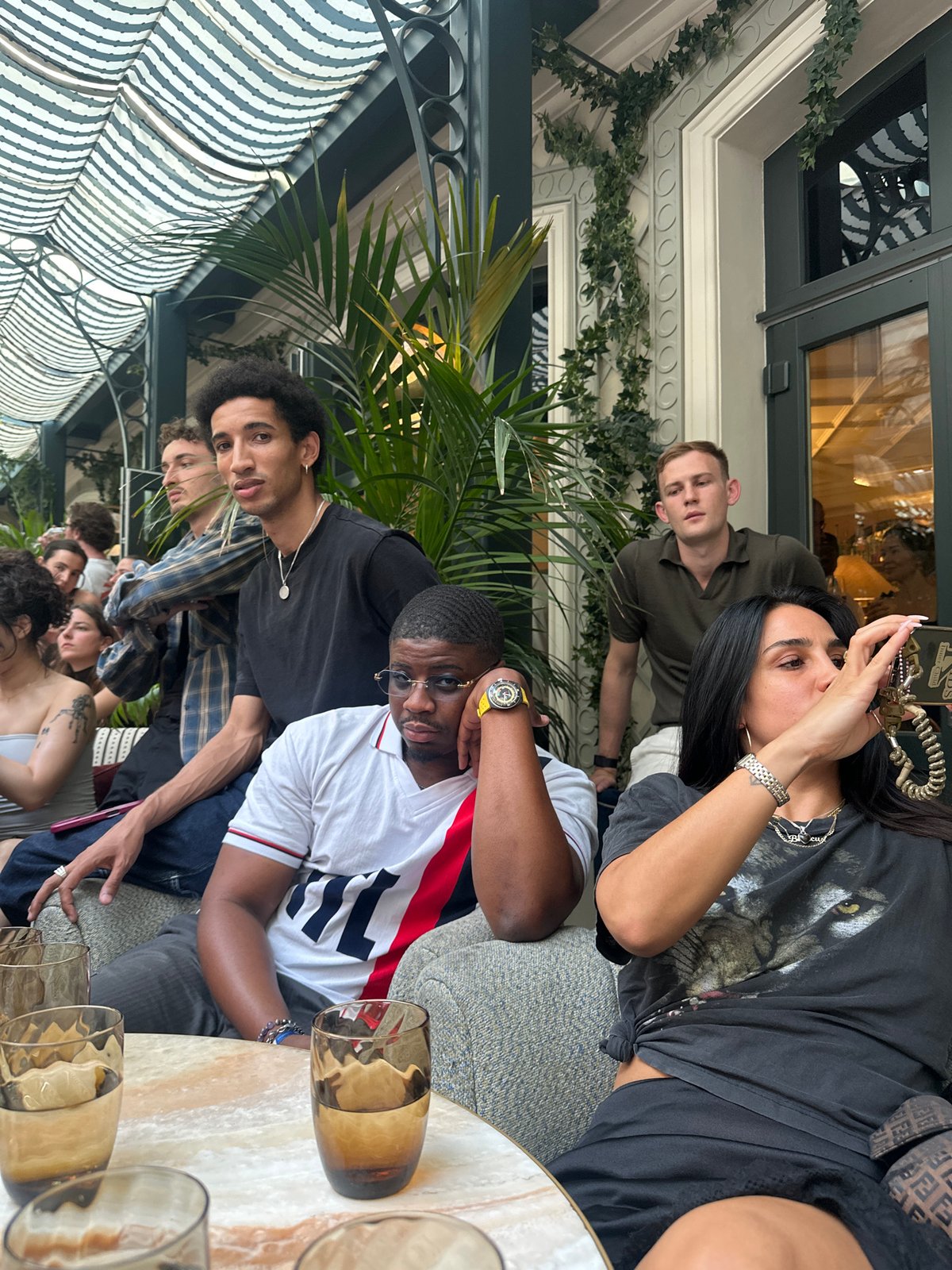 Friends gather at Paris café, PSG jerseys spotted