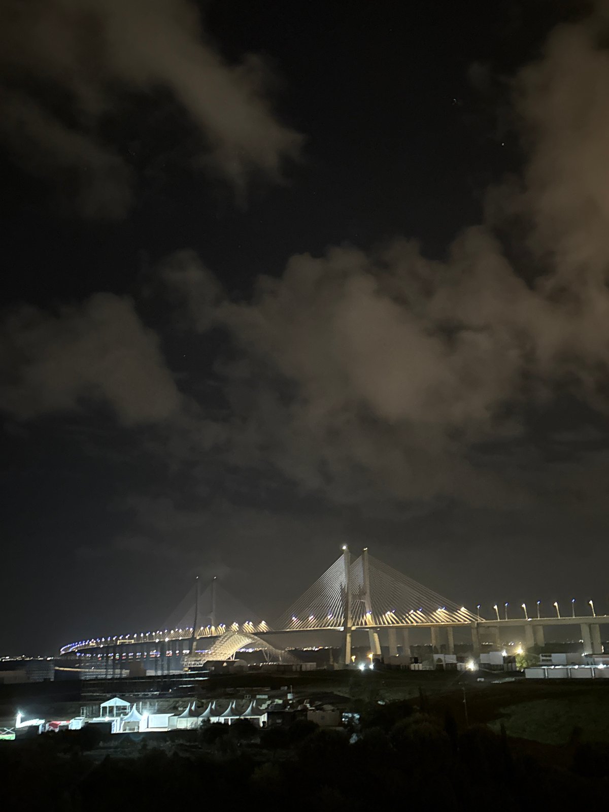Illuminated bridge lights up night sky in Loures, Portugal