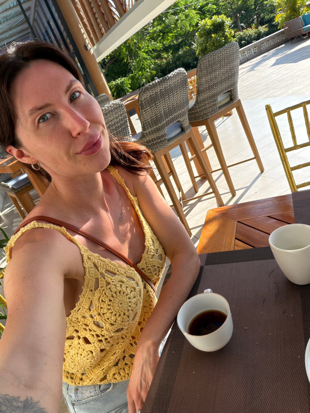 Woman takes selfie at outdoor cafe in Vietnam