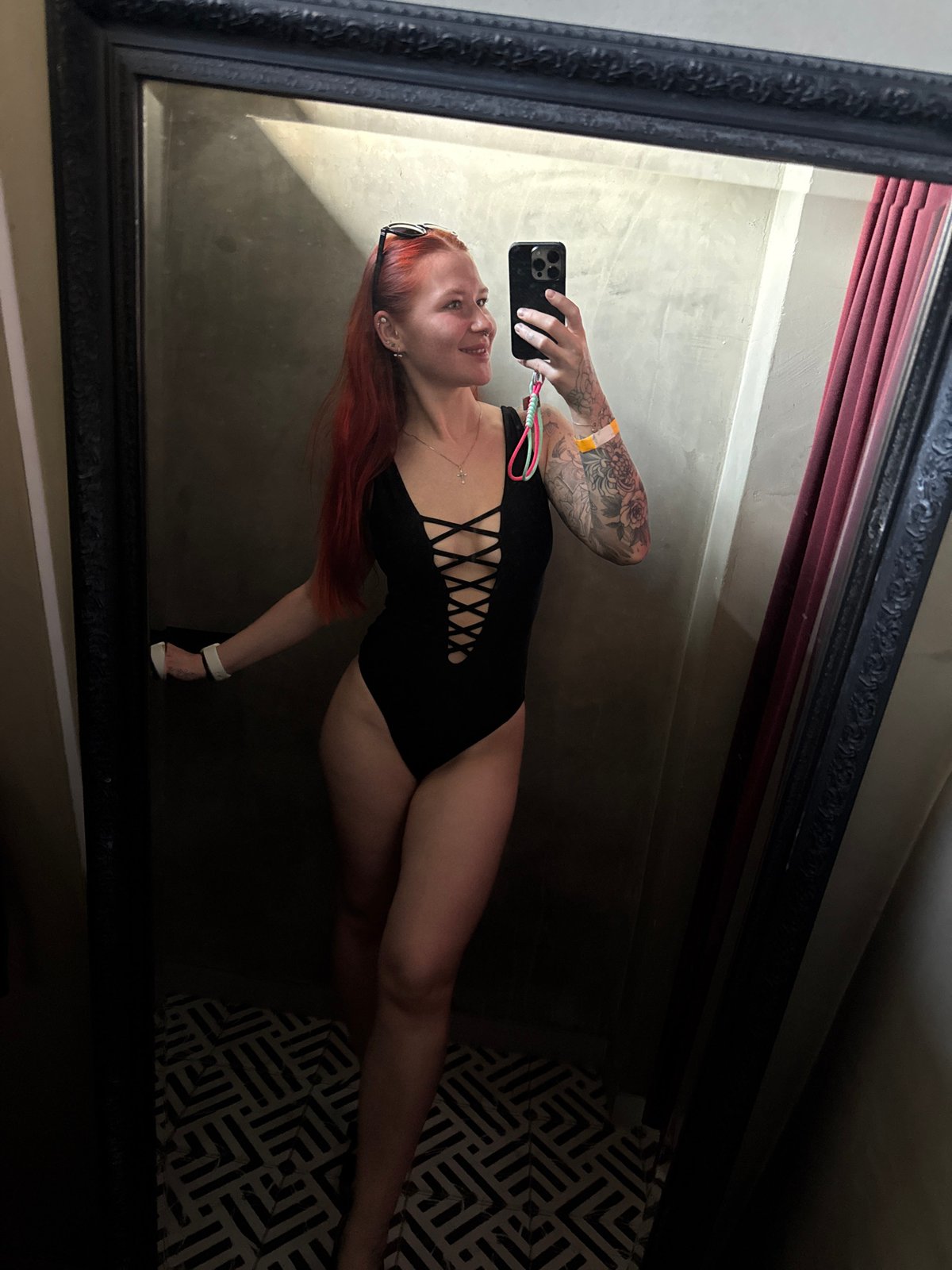 Woman in swimsuit poses before mirror in Rostov-on-Don