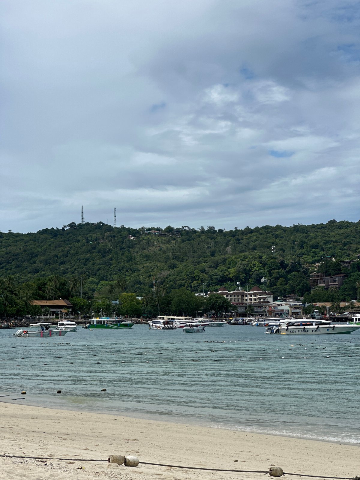 Ao Nang beach on a quiet morning, boats and limestone cliffs