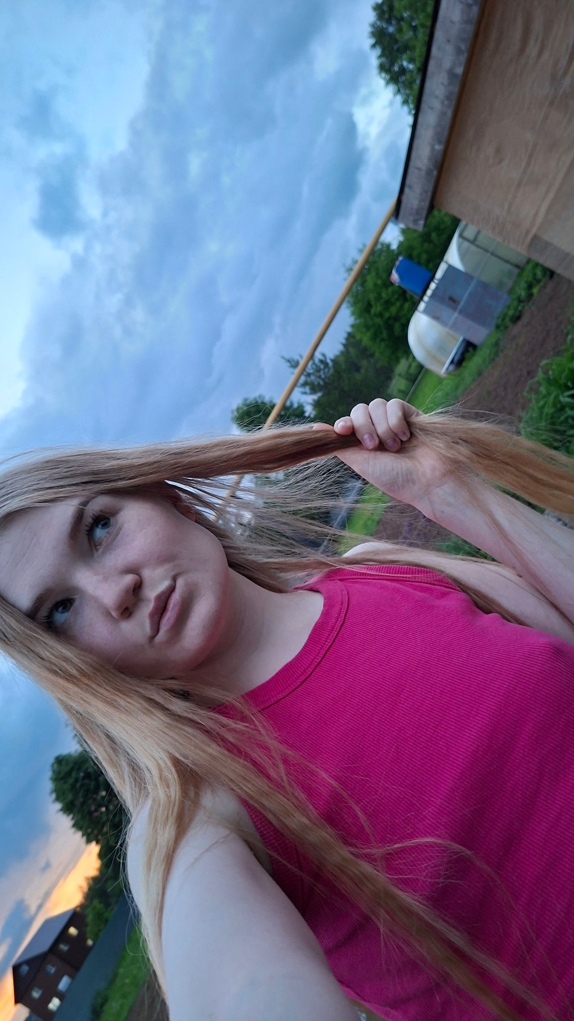 Young Woman Documents Evening Garden Photography Session in Rural Russia