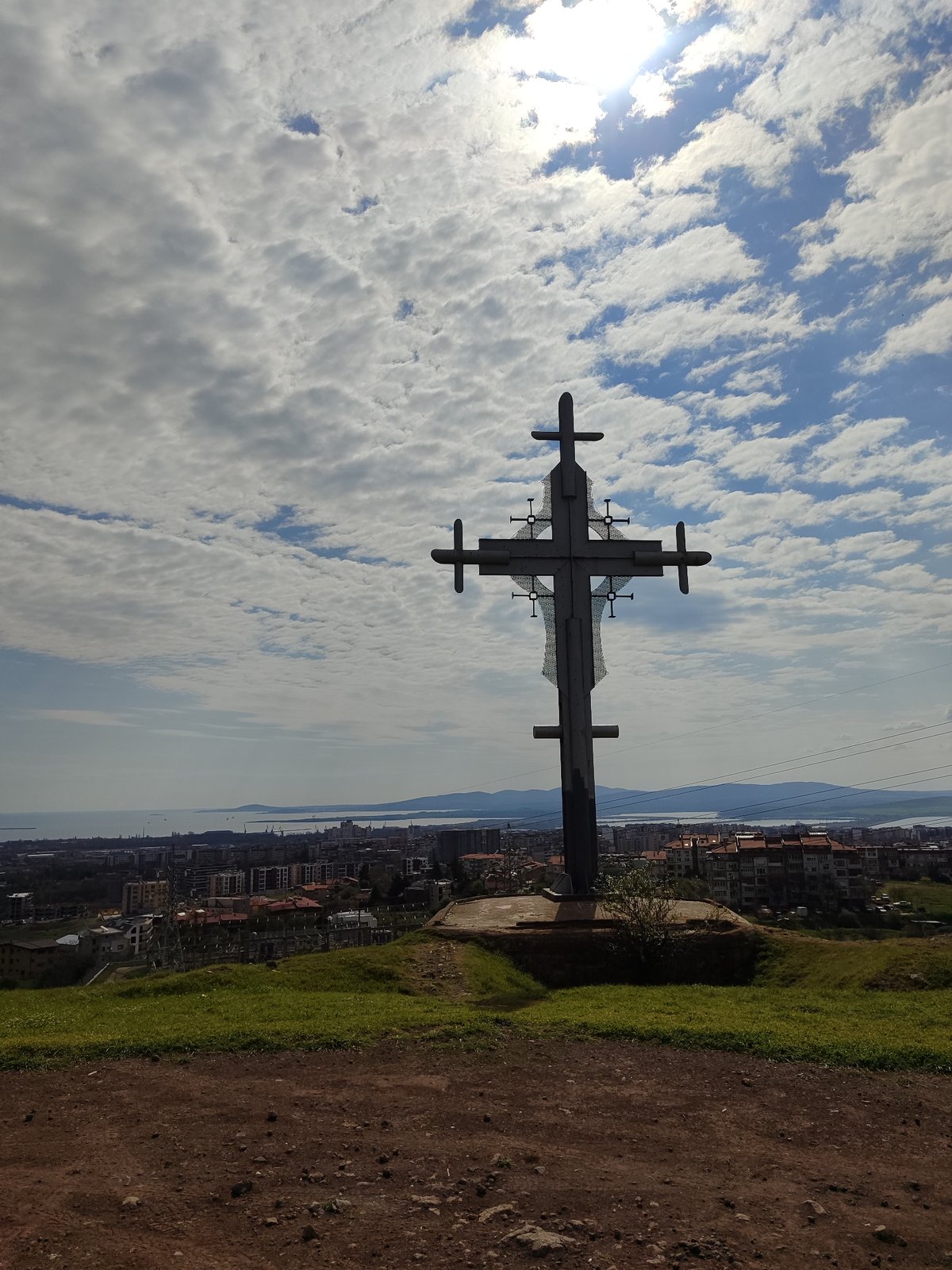 Metal cross stands on hill overlooking Burgas, Bulgaria