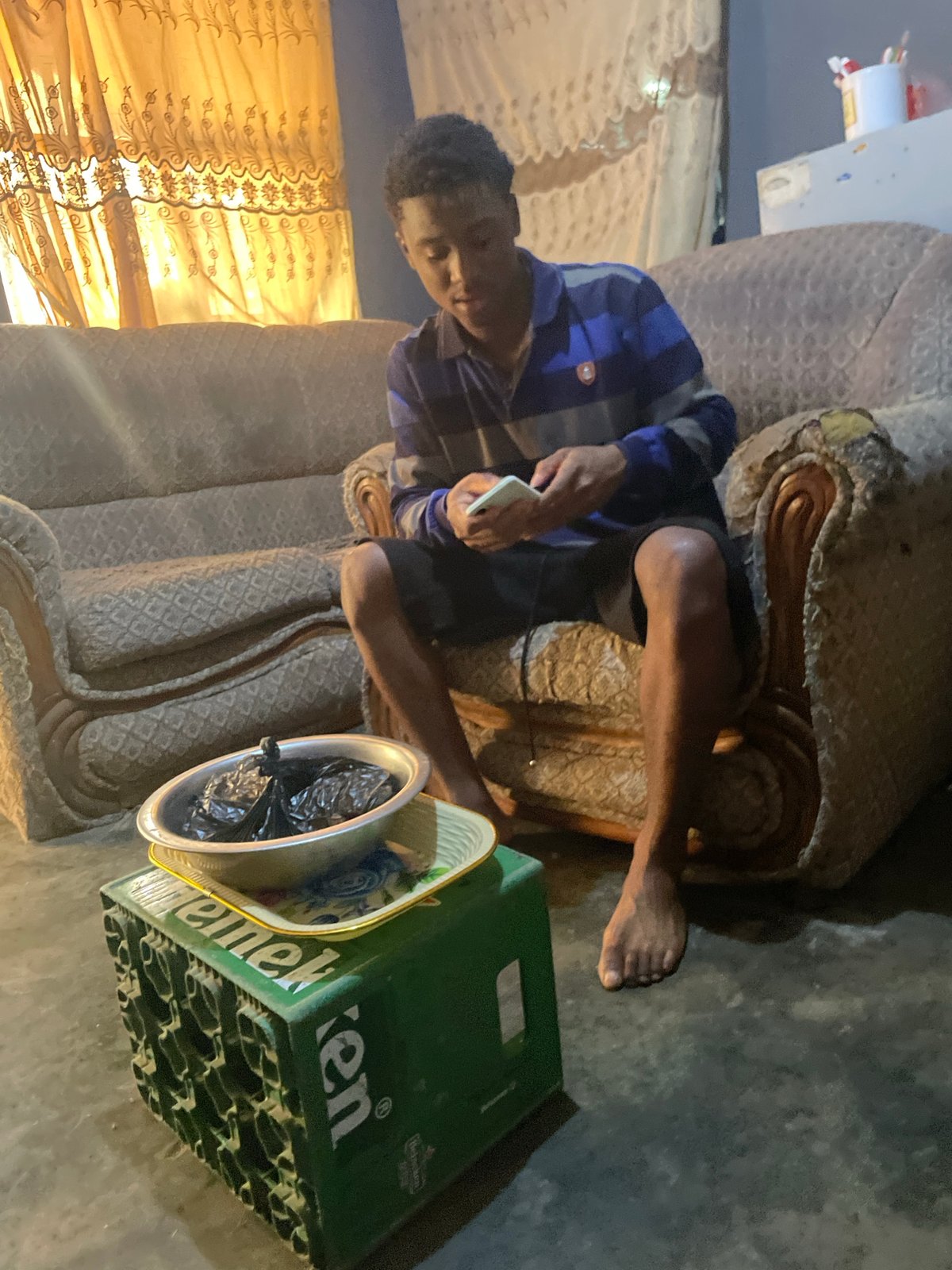Morning scenes from Jos: phone user, indoor woman, rickshaw