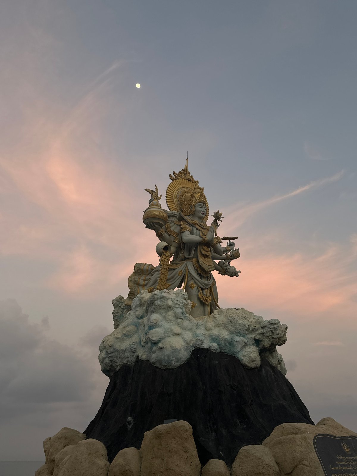 White and gold multi-armed Hindu deity statue in North Kuta