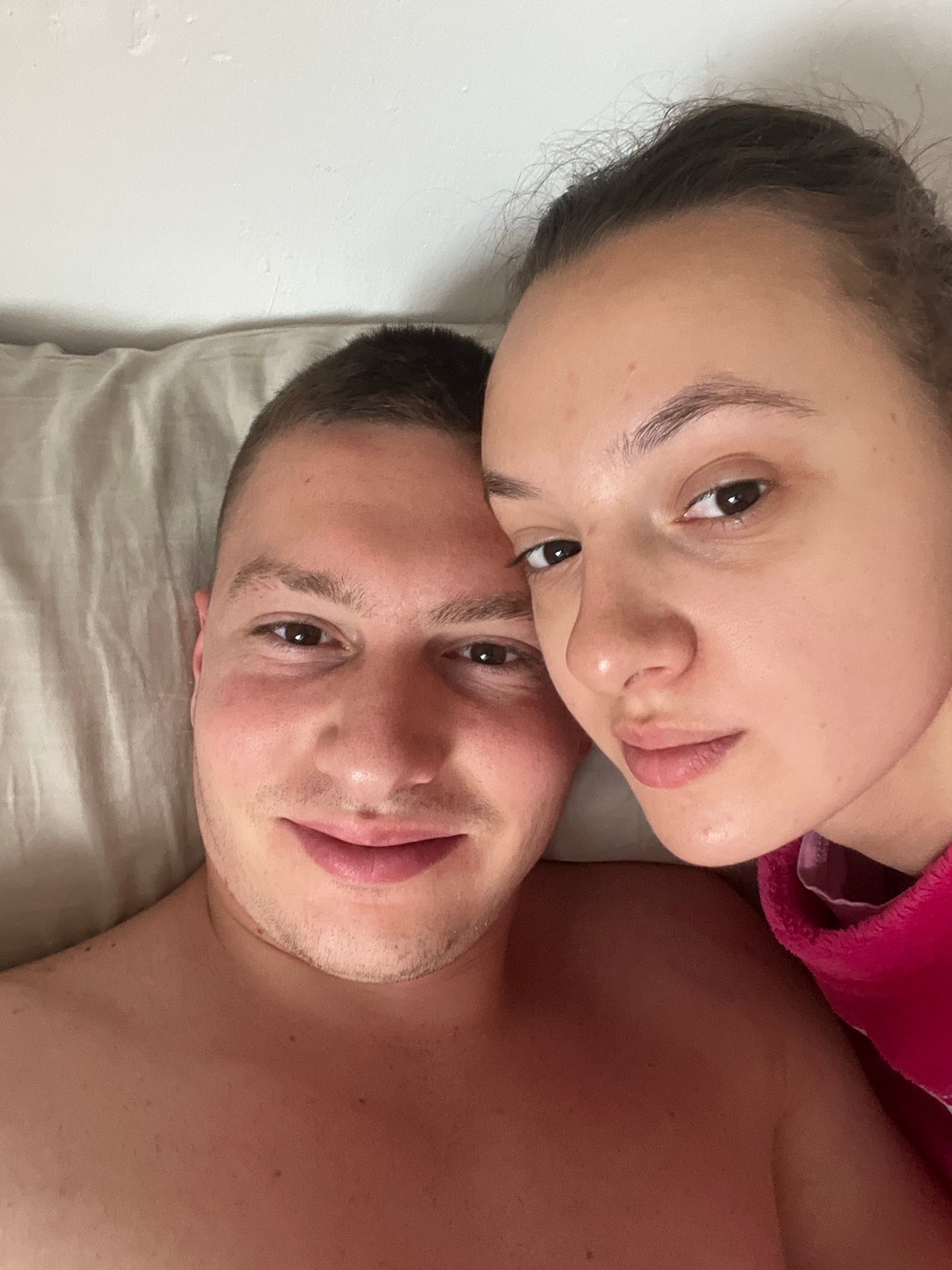 Couple photographed on bed in Saarbrücken morning scene