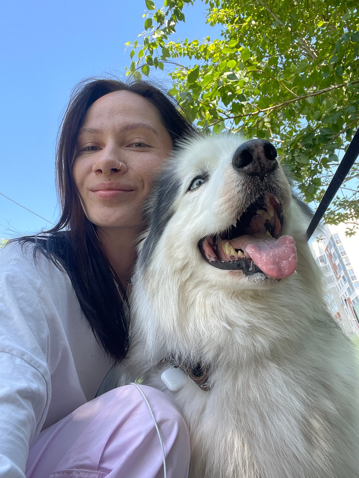 Woman takes selfie with large white dog in Izhevsk