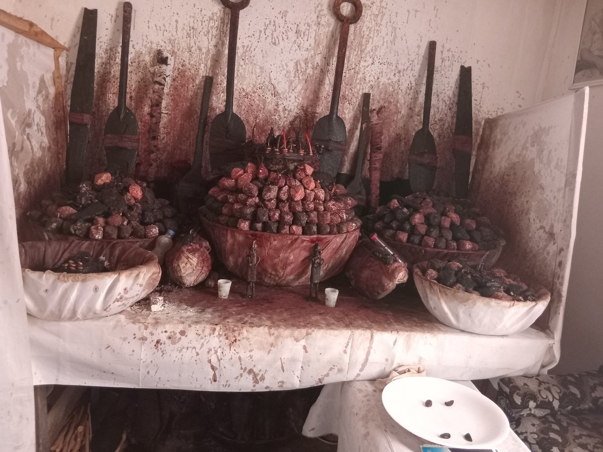 Children play amid traditional shrine elements in Shagamu, Nigeria
