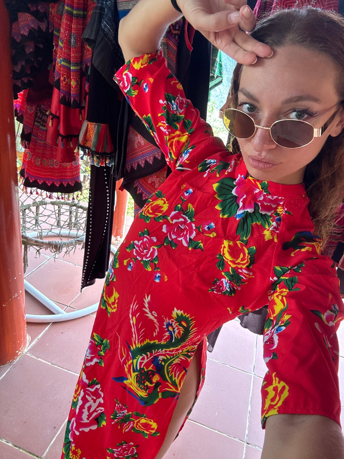 Woman poses for selfie in floral dress in Vietnam