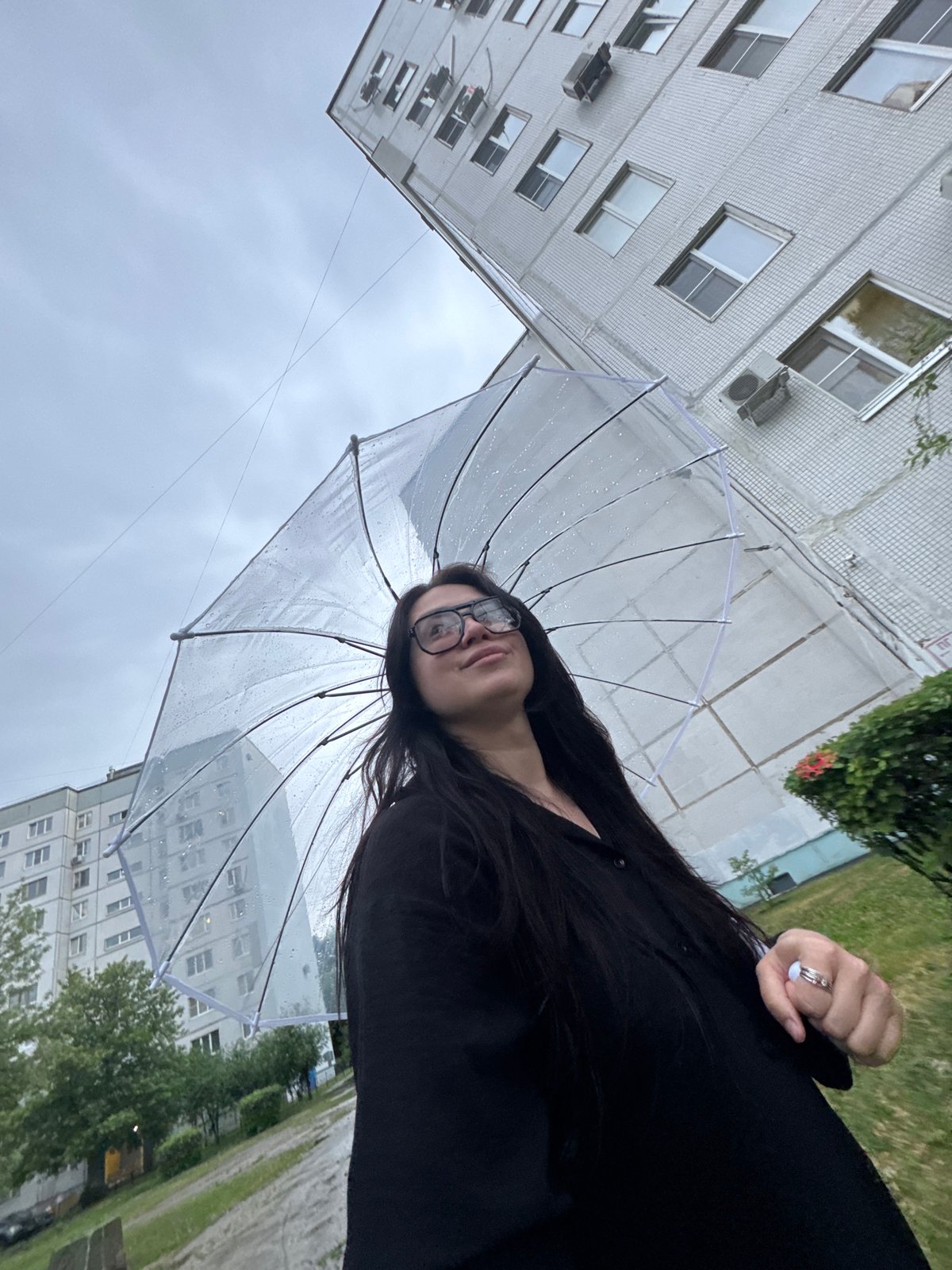 Woman photographed multiple times during cloudy afternoon in urban setting