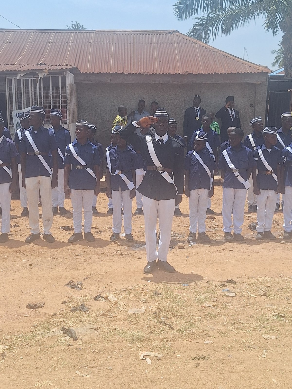 Uniformed group holds ceremony with flags in Sabon Tasha