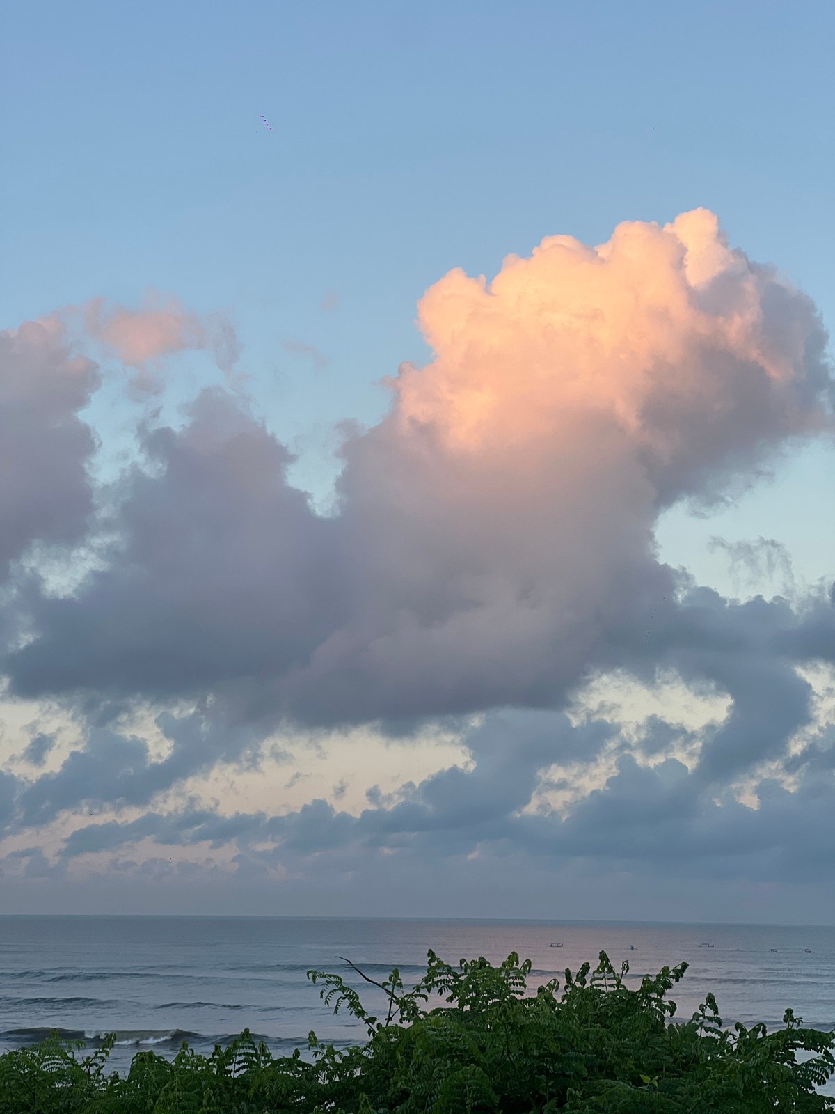 Evening scenes across Indonesia show coastal calm, rural fields
