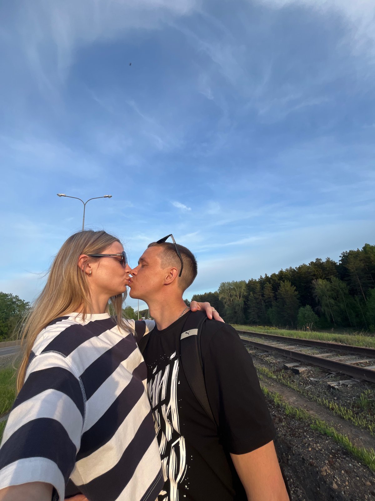 Couple stages romantic photoshoot on railway tracks in Chaikovsky