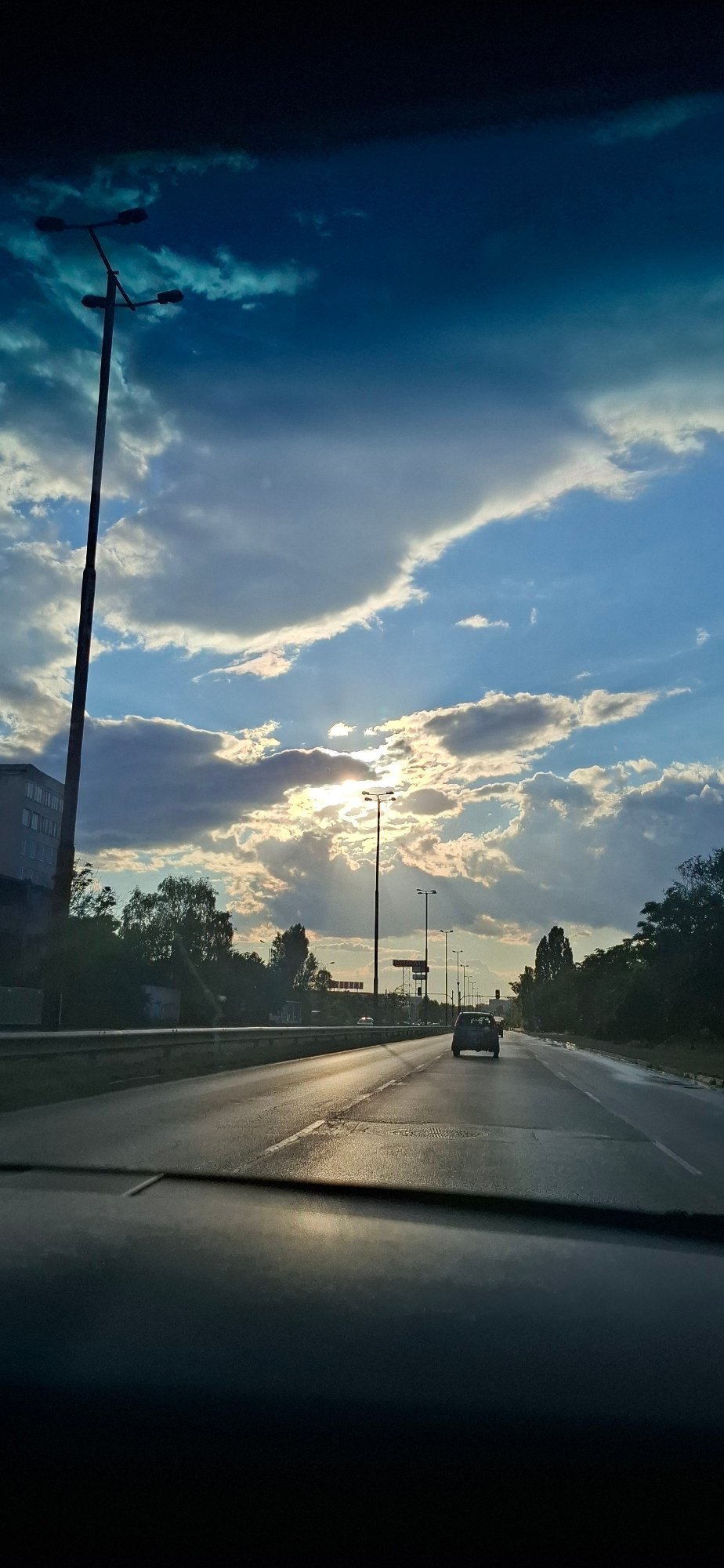 Dramatic storm-break sky over highway and construction site