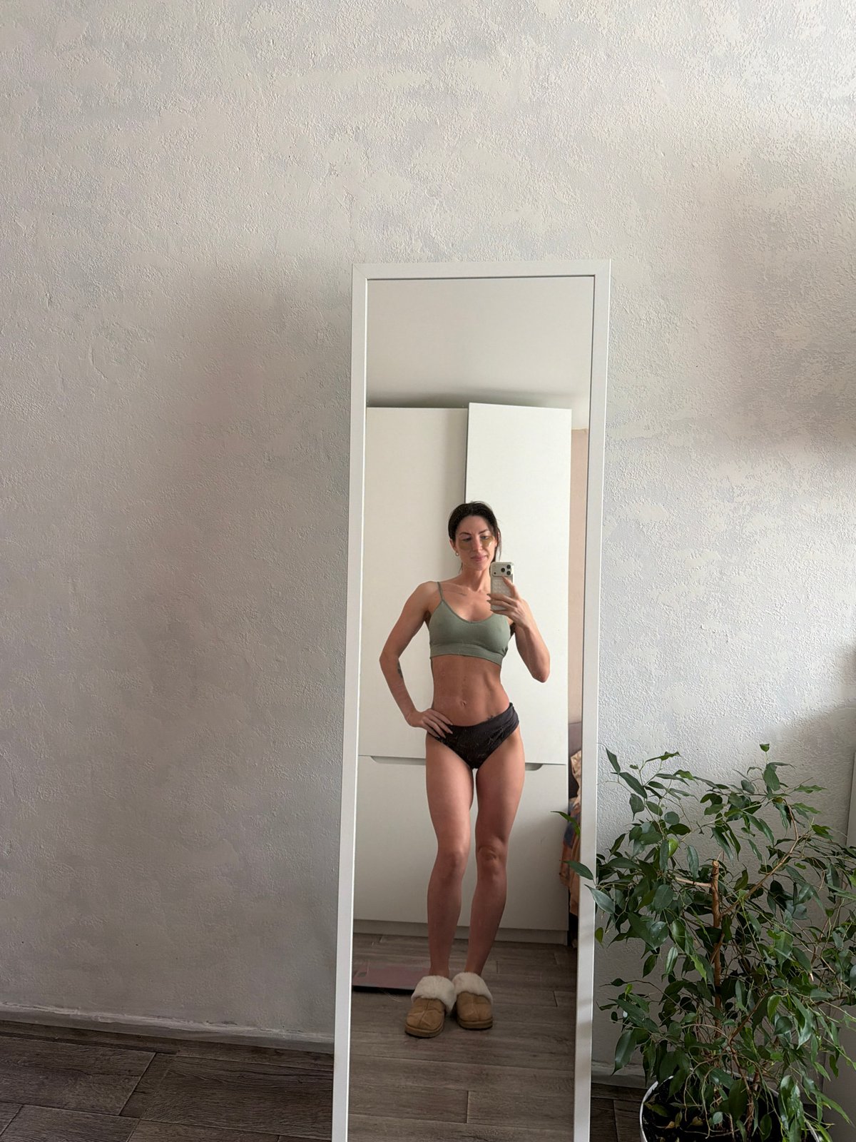 Woman takes mirror selfie in Perm residential setting