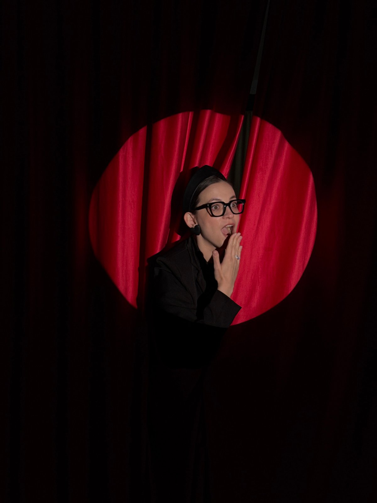 Person spotted in spotlight on red surface in Chaikovsky