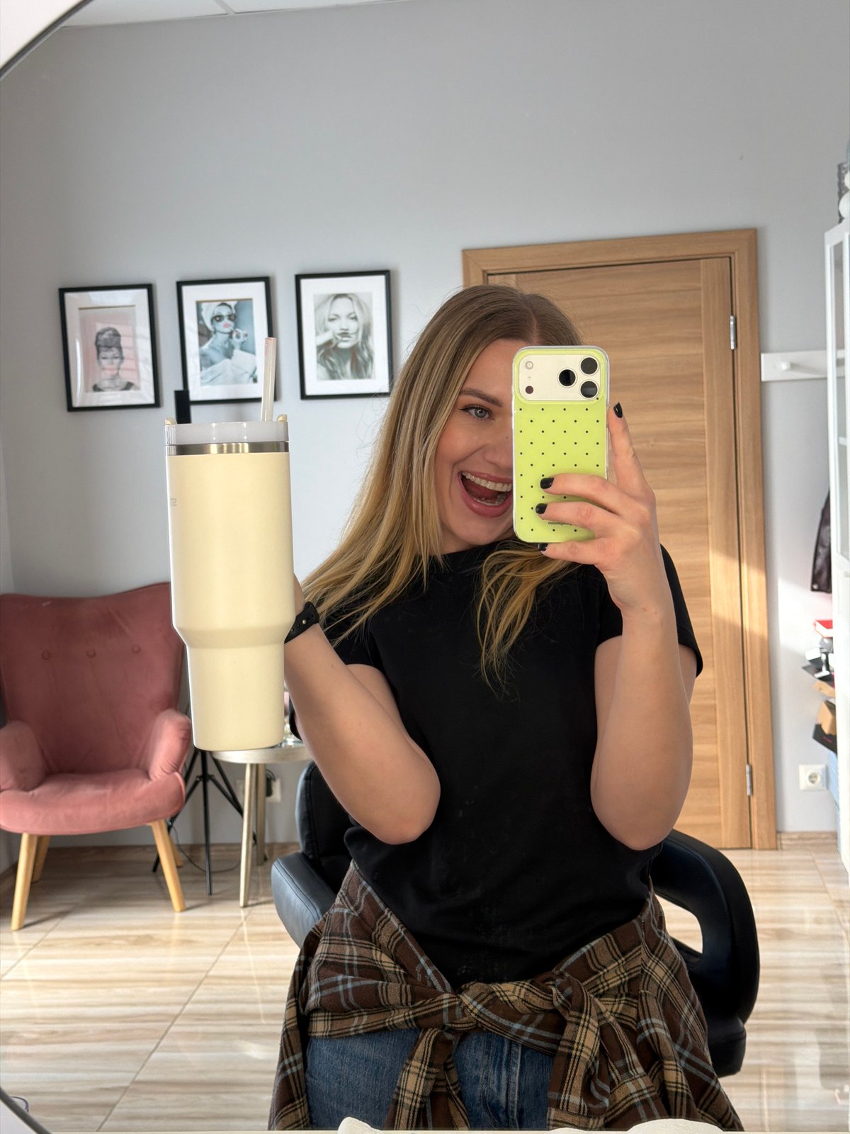 Woman takes mirror selfie with polka dot phone in Riga