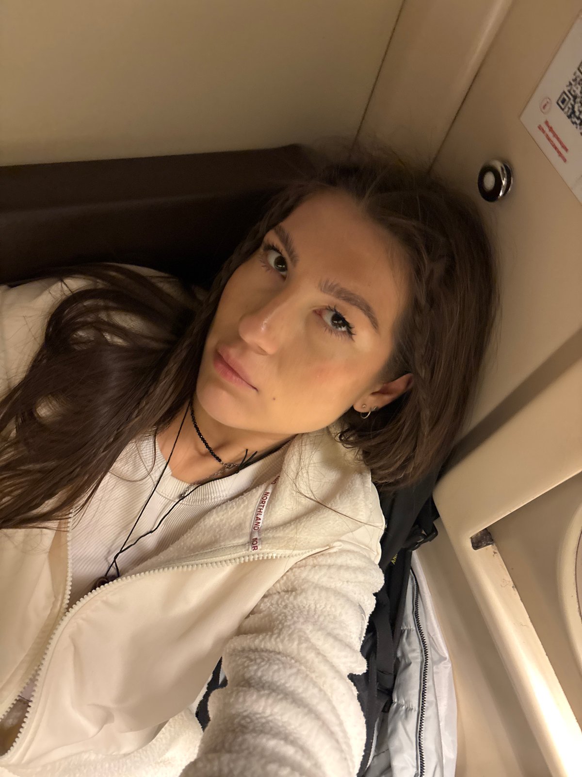 Woman photographed in train compartment during evening journey near Шемордан