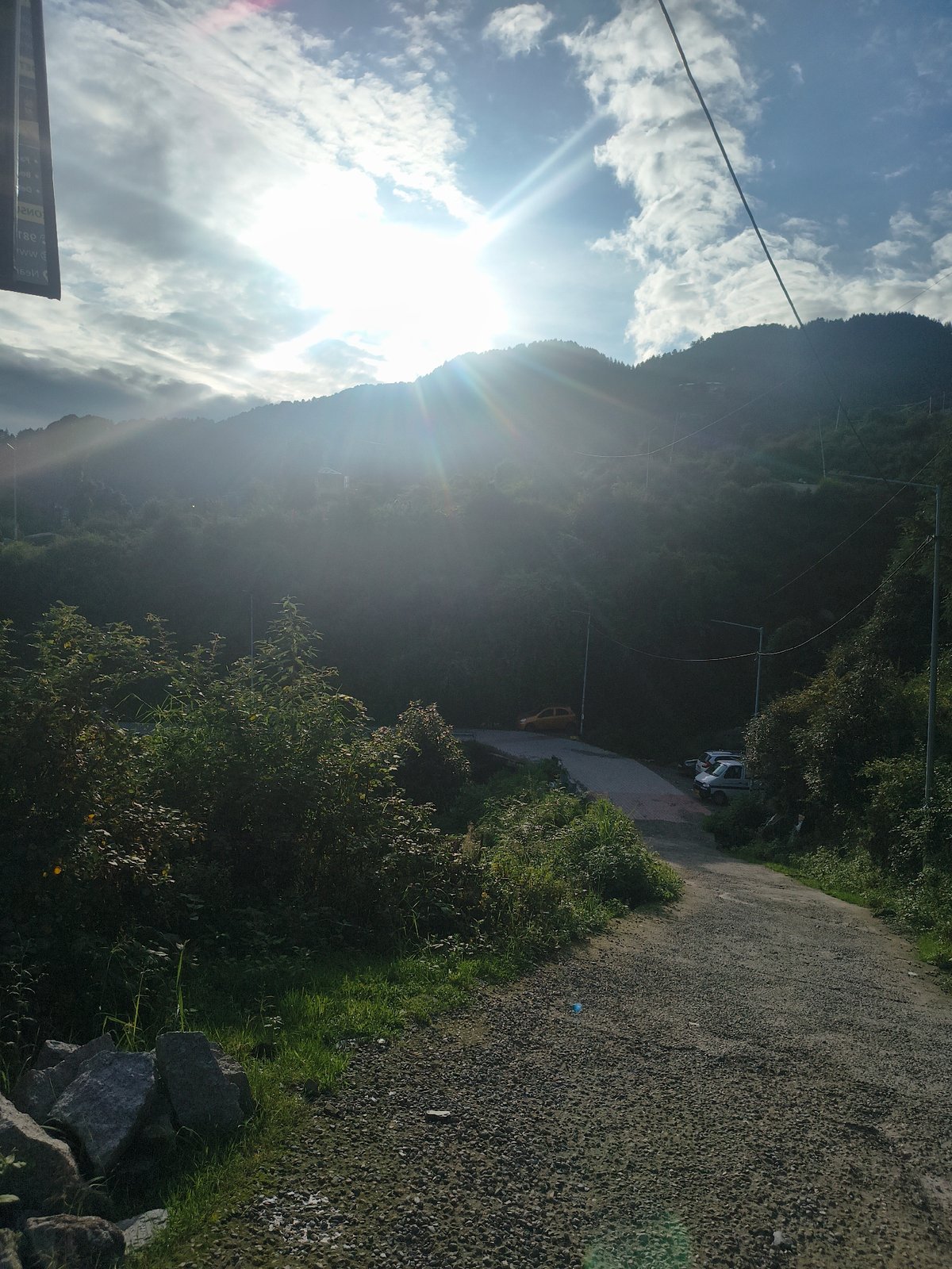 Hiking a scenic mountain path to a valley village viewpoint