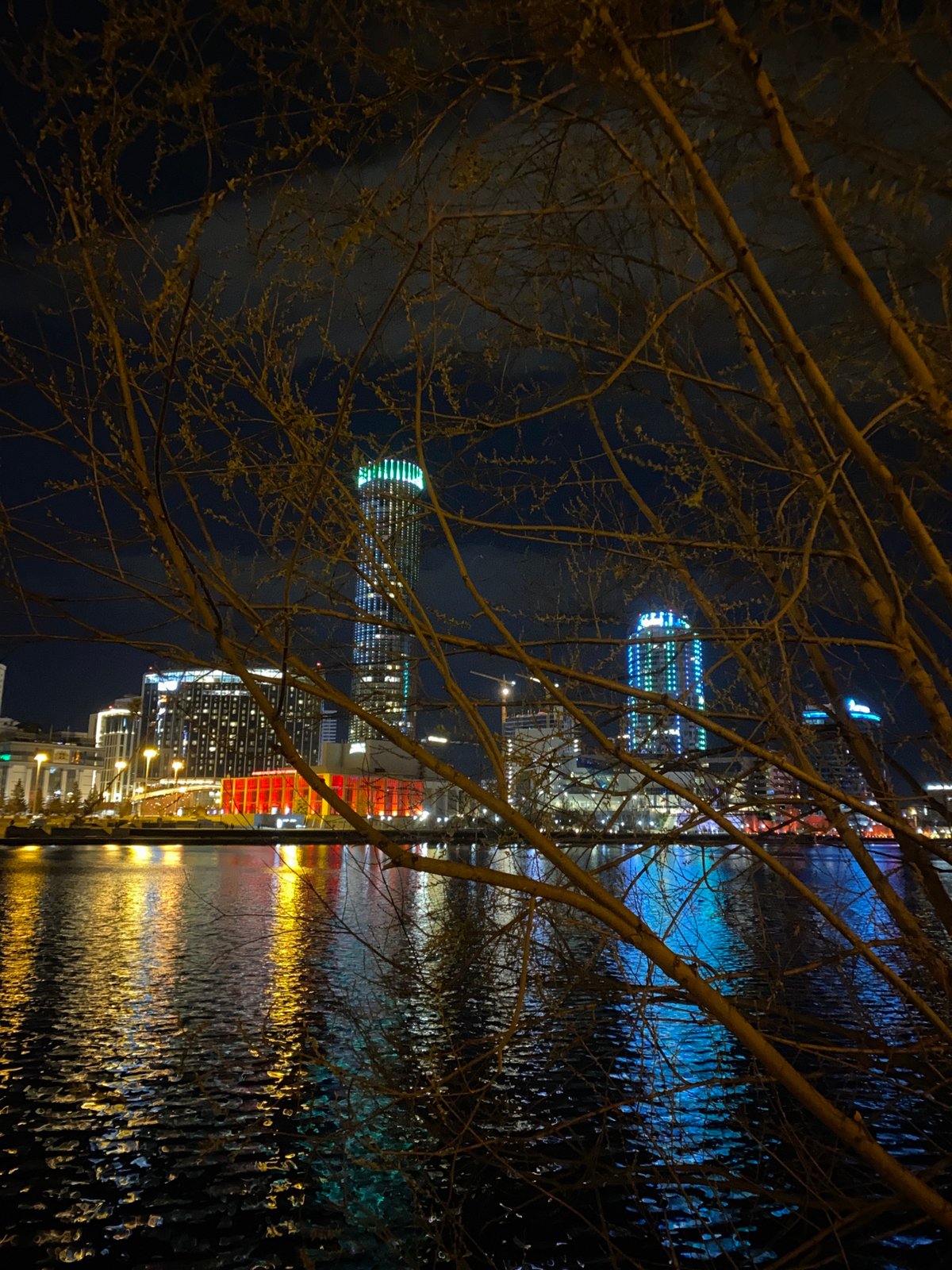 Nighttime photography session documents Yekaterinburg waterfront reflections