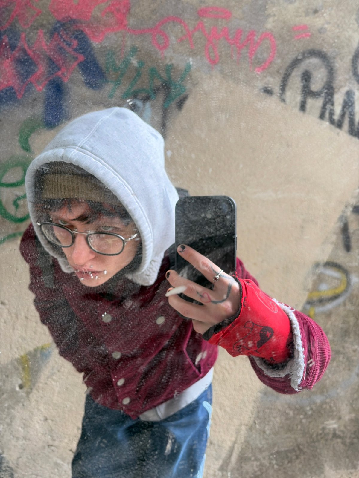 Person takes mirror selfies amid graffiti in Sofia