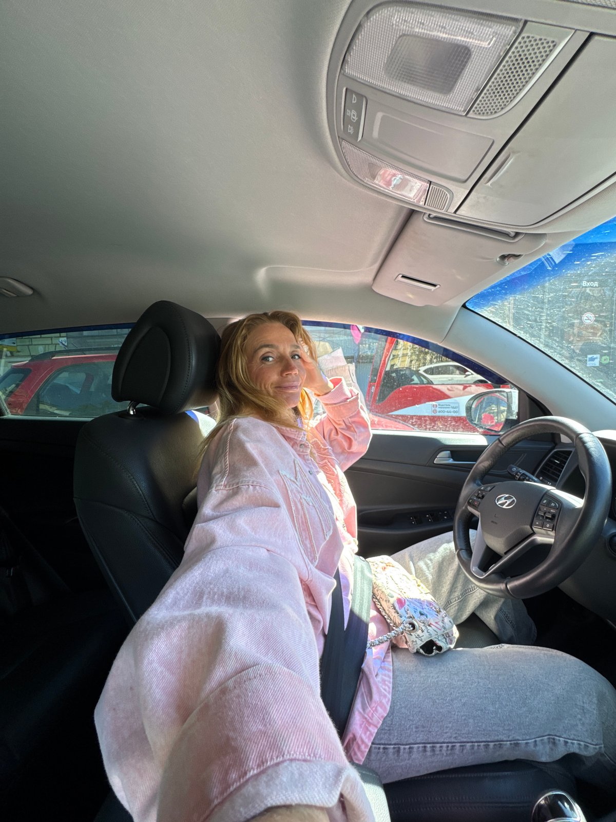 Woman sits in Hyundai during heavy traffic in Saint Petersburg