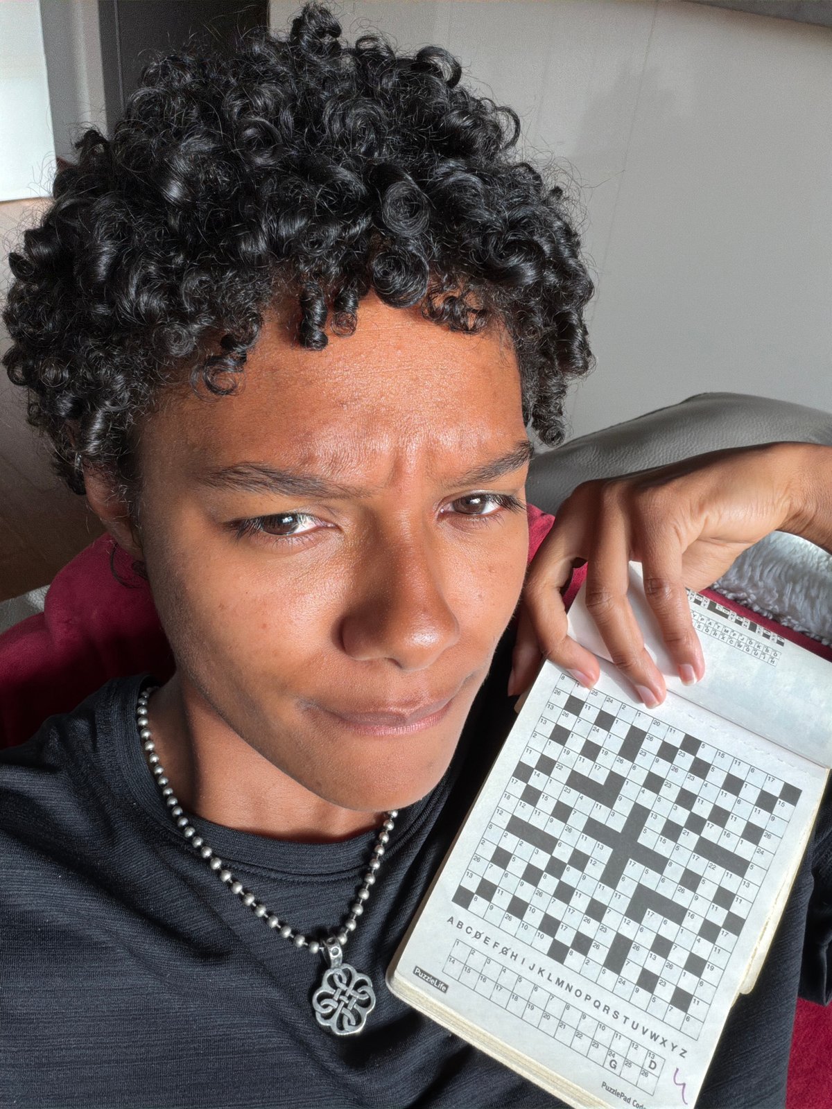 Person works crossword puzzle while resting in Champs-sur-Marne