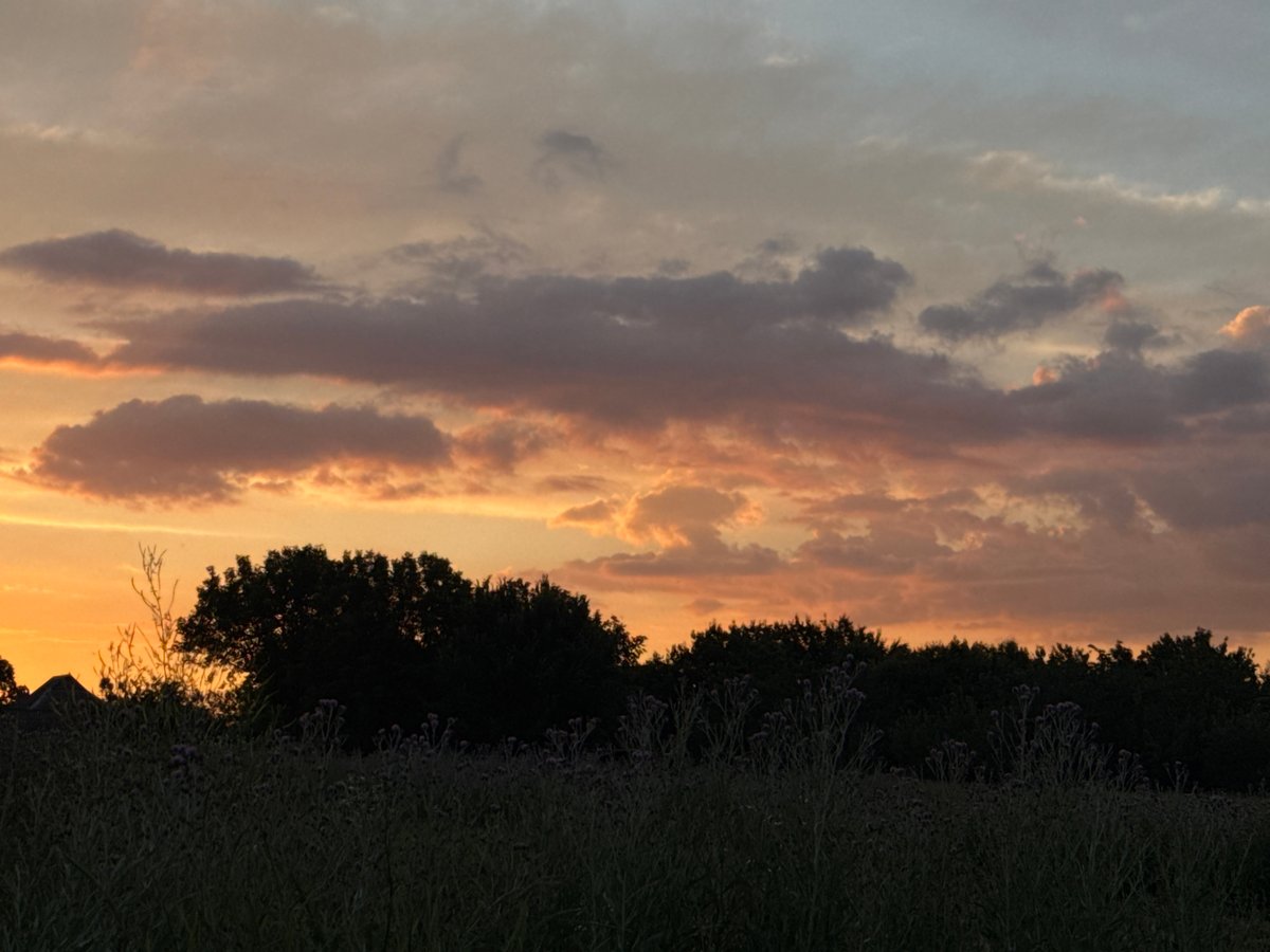 Golden hour over rural Chervonosilske, clouds and water at dusk