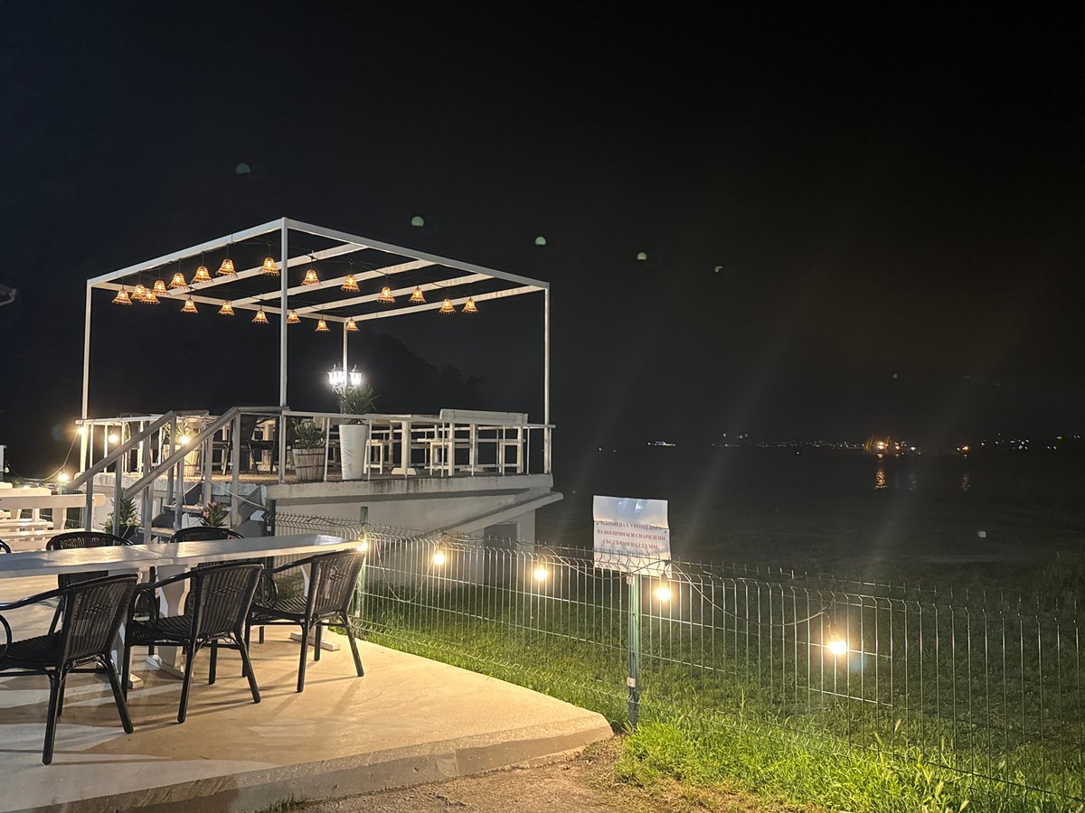 Empty outdoor restaurant patio observed at night