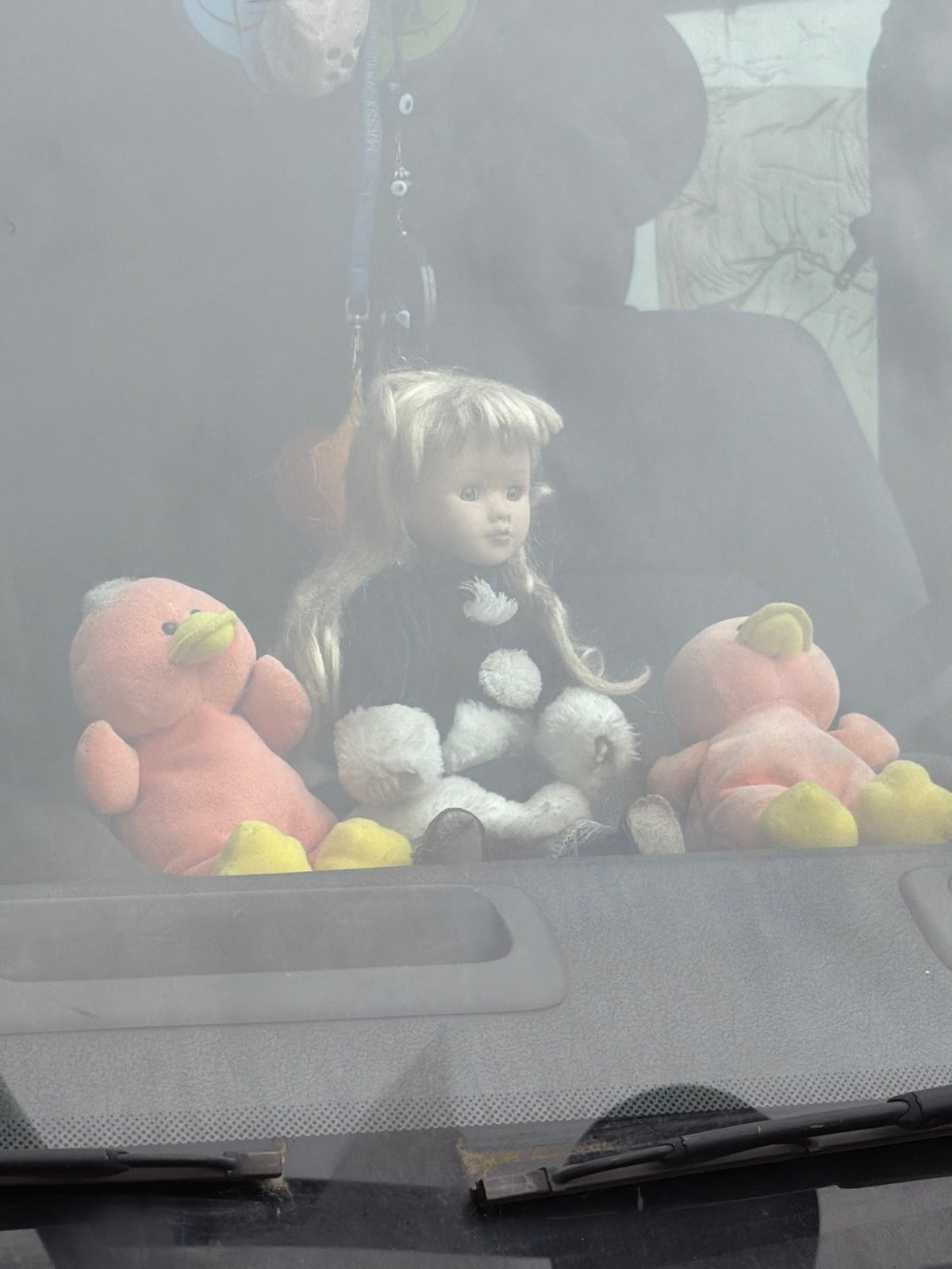 Children's toys viewed through dusty window in Montreuil