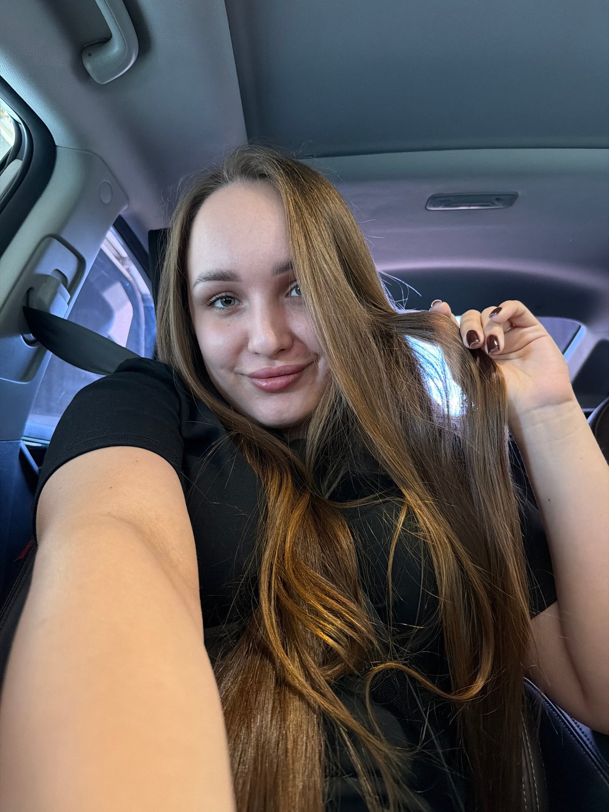 Woman films selfies during car wash in Chaikovsky, Russia