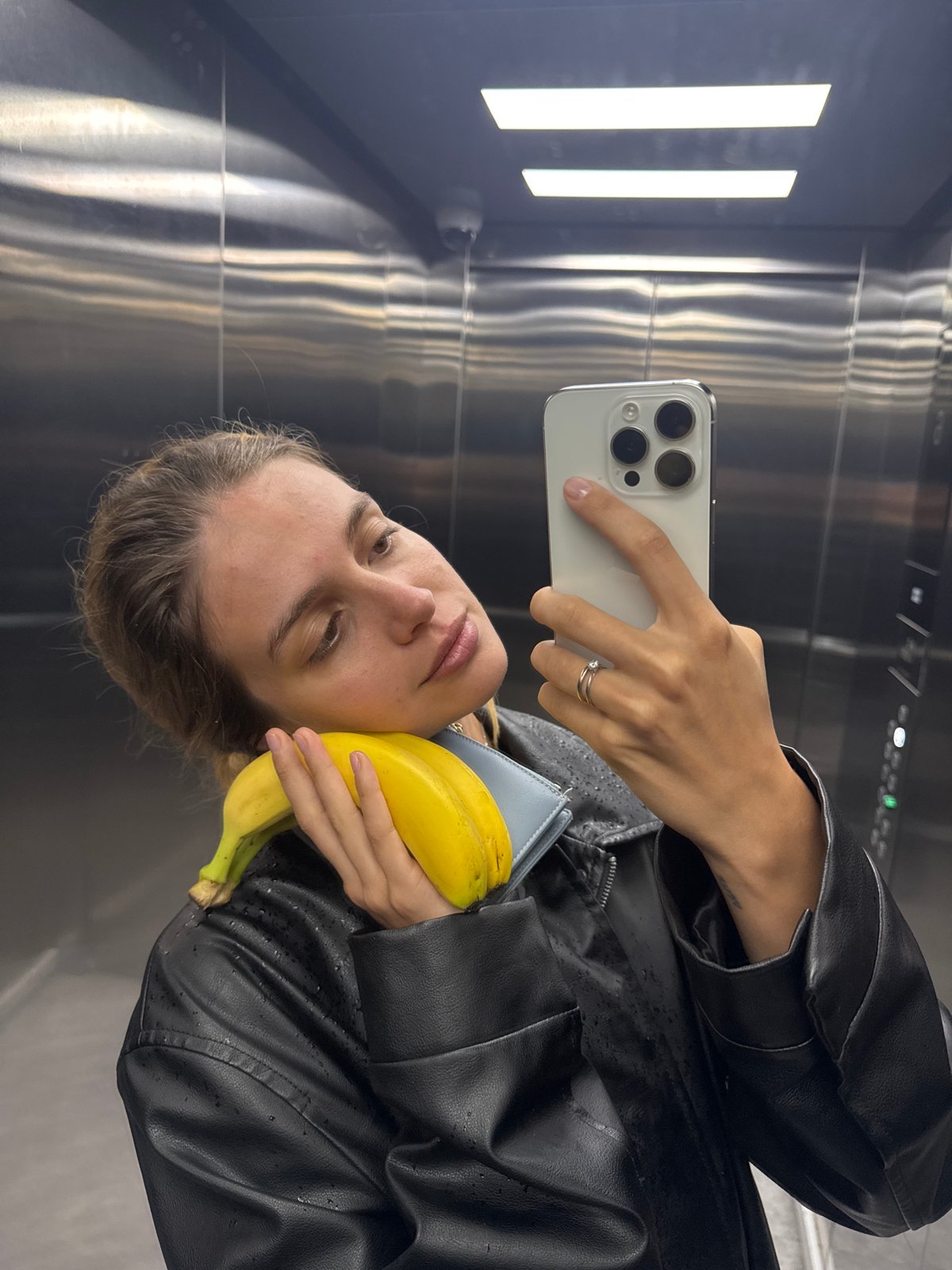 Woman takes banana selfie in elevator