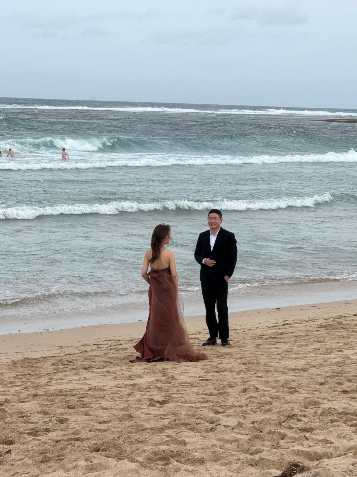 Formal beach photoshoot at the water's edge in Kuta Selatan