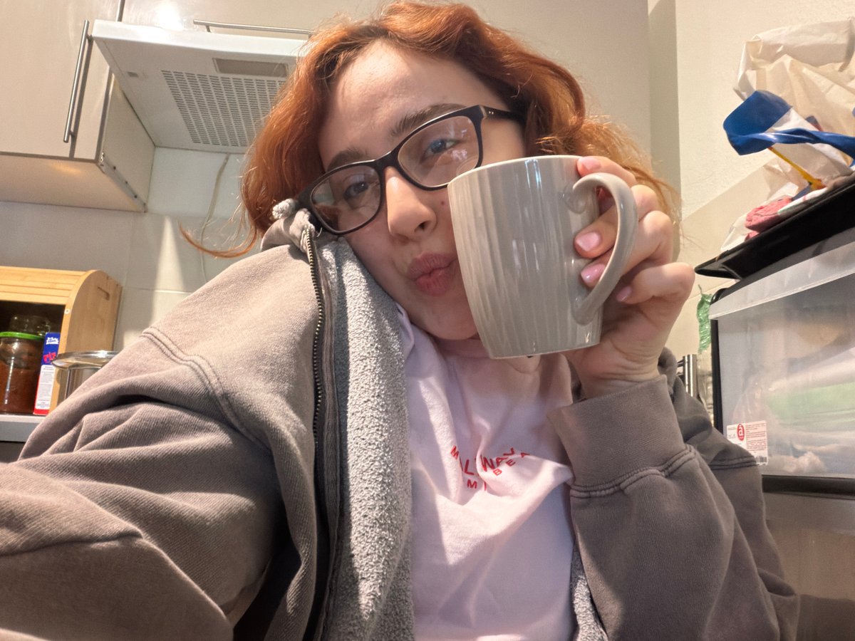 Woman takes morning selfies with coffee mug in Strasbourg